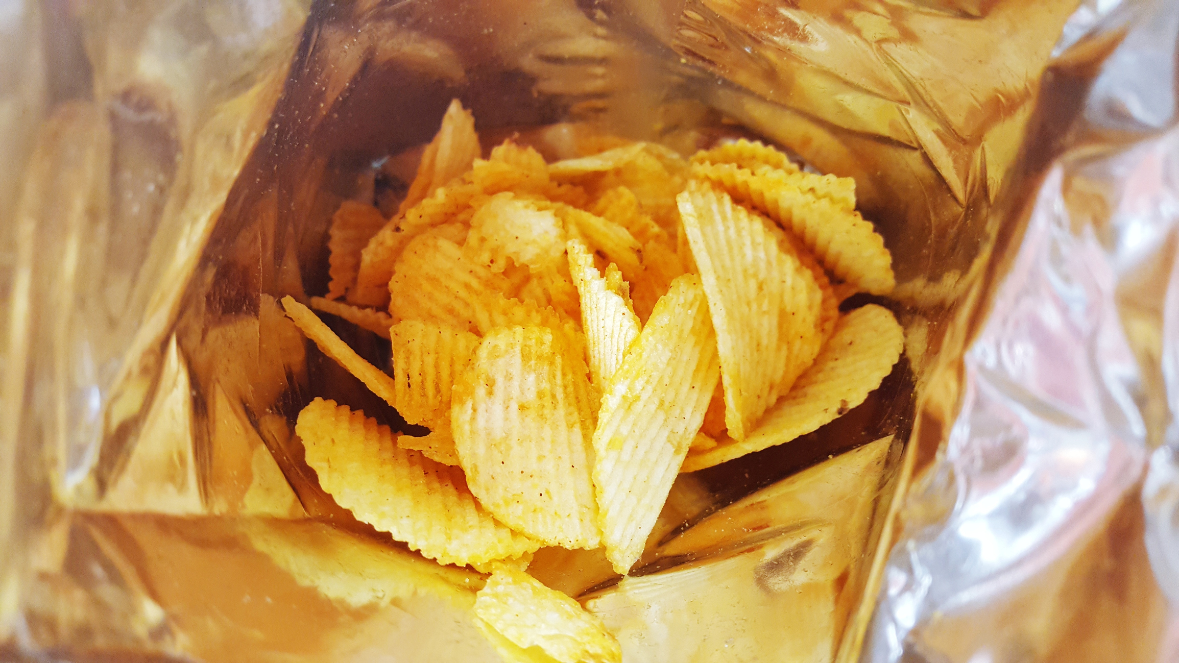 Close-Up Of Potato Chips In Foil Container