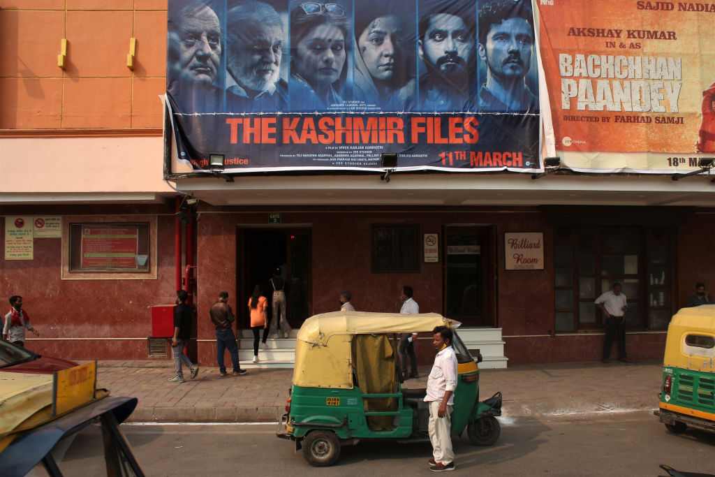 An auto rickshaw driver waits for customers in front of a cinema screening the Bollywood movie "The Kashmir Files" in New Delhi, India on Mar. 17, 2022. (Mayank Makhija/NurPhoto via Getty Images)