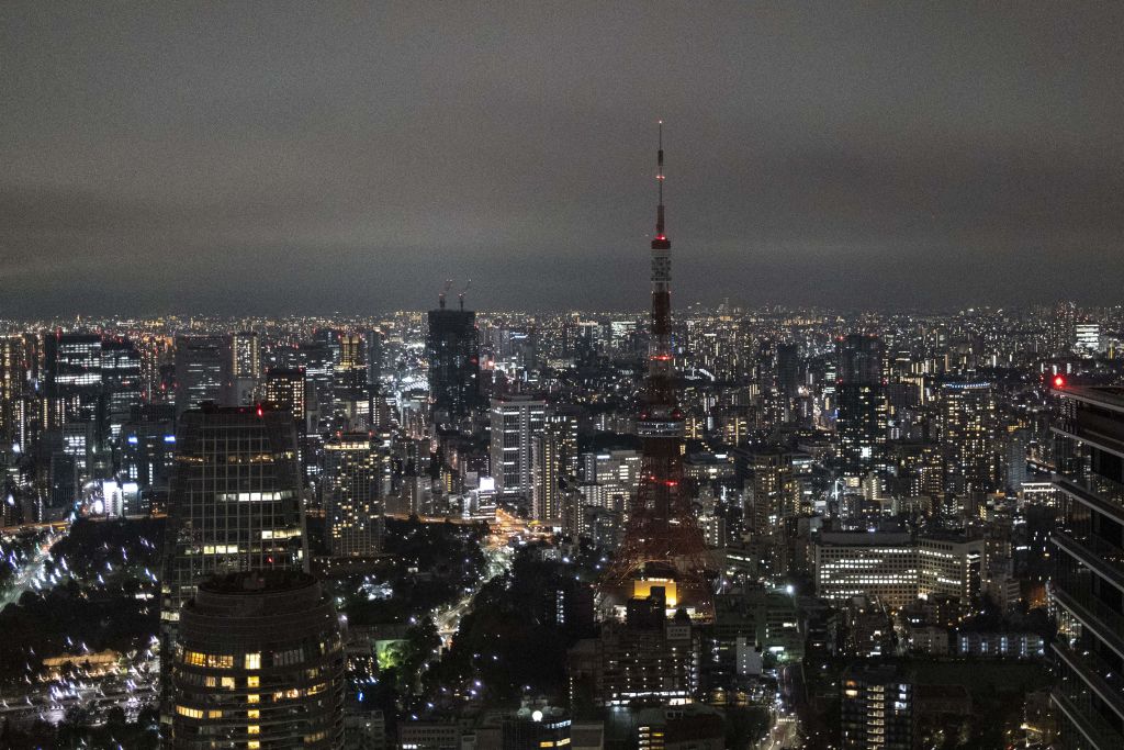 The Tokyo Tower is seen with its lights turned off after 9pm as part of energy-saving measures following a government electricity supply warning for the capital and surrounding areas, in Tokyo on March 22, 2022. (CHARLY TRIBALLEAU/AFP—Getty Images)
