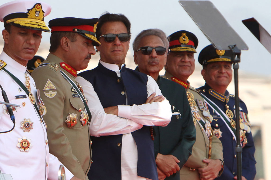 Pakistan's Prime Minister Imran Khan (3L) and President Arif Alvi (3R) watch fighter jets perform during the Pakistan Day parade in Islamabad on Mar. 23, 2022. (GHULAM RASOOL/AFP via Getty Images)