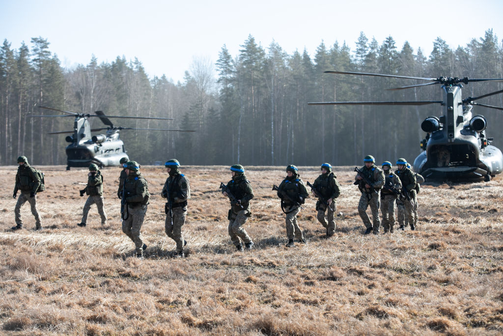 Members of Lithuania Armed forces gets off from Royal Air Force Chinook helicopters on March 1, 2022 in Kazlu Ruda, Lithuania. Saber Strike 2022 is an element of the large-scale exercise Defender-Europe 2022 military drills between U.S. troops and allied forces. (Paulius Peleckis-Getty Images)