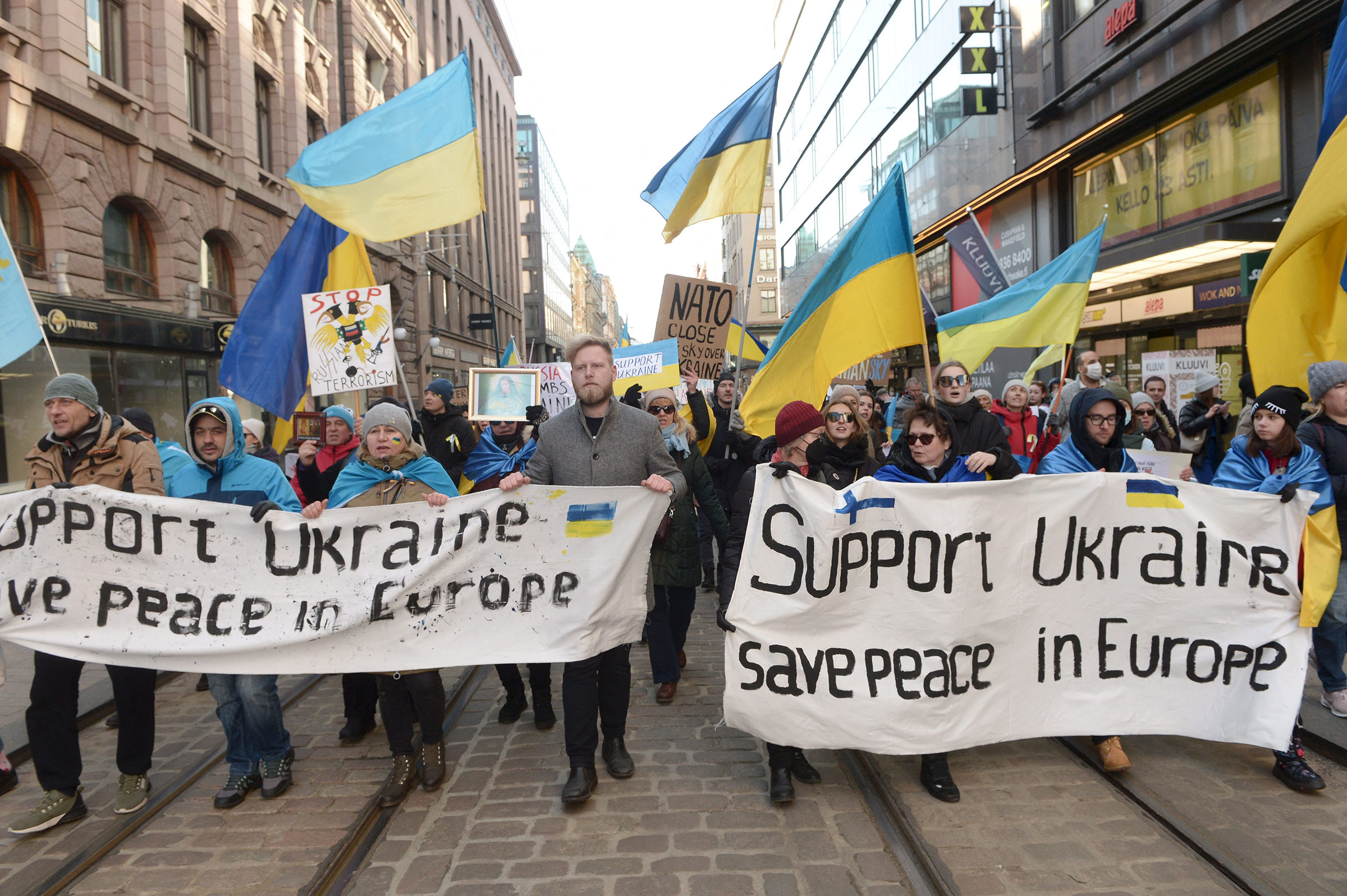 Protestors show their support for Ukraine as they take part in a demonstration against Russia's invasion of Ukraine, in Helsinki on March 5, 2022. (Mikko Stig—Lehtikuva/AFP/Getty Images)