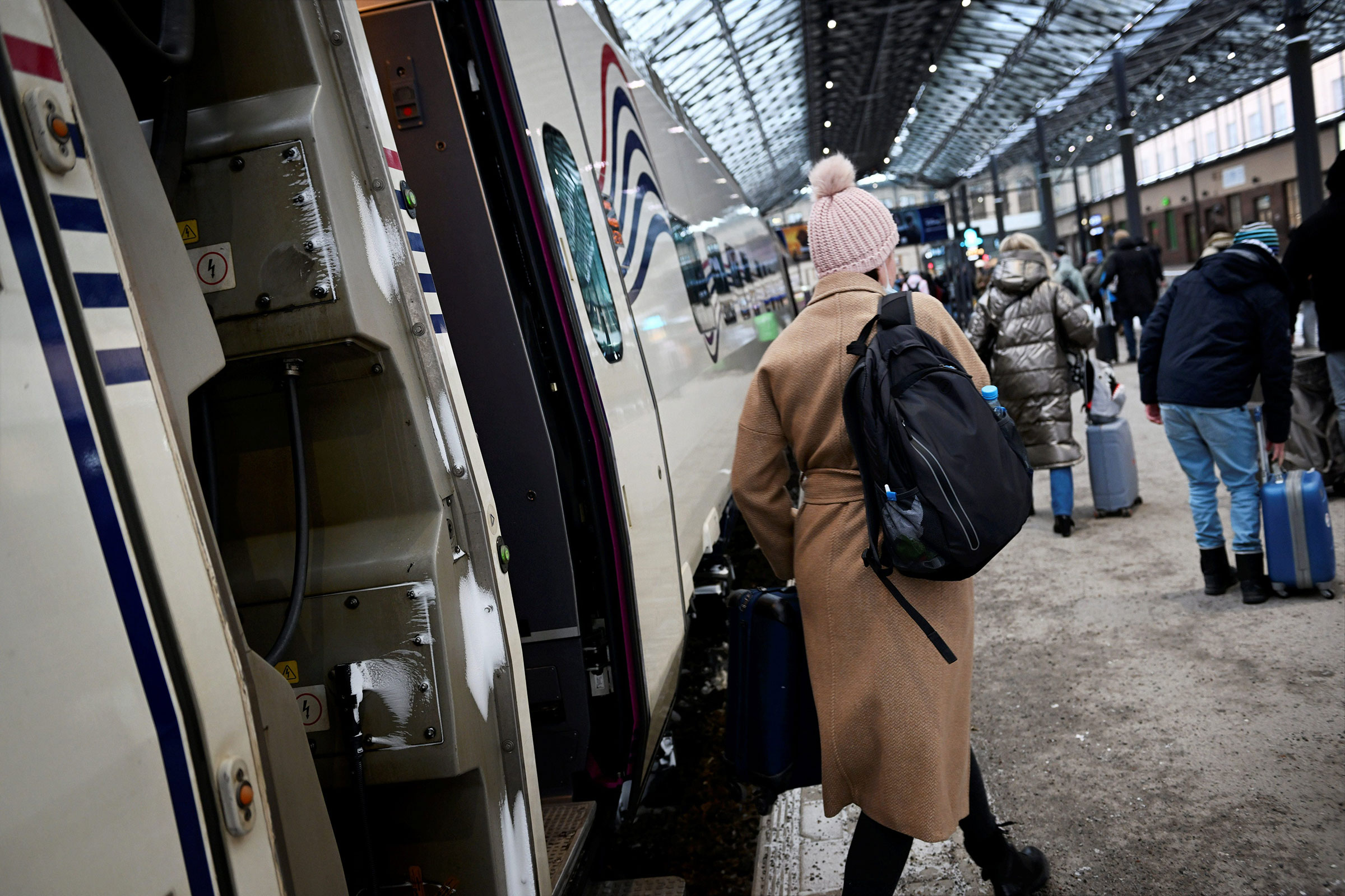 People get off the Allegro train from from St. Petersburg at the central railway station in Helsinki on March 9. (Antti Aimo-Koivisto—Shutterstock)