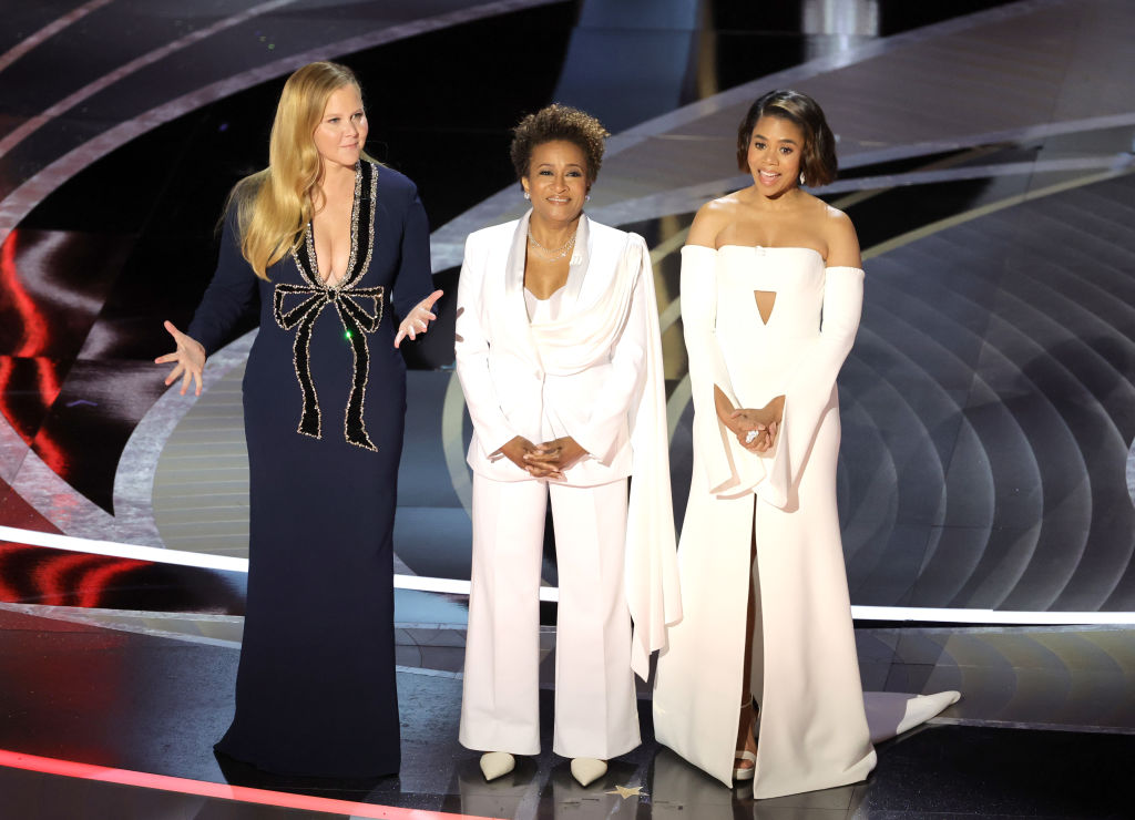 Co-hosts Amy Schumer, Wanda Sykes, and Regina Hall speak onstage during the 94th Annual Academy Awards at Dolby Theatre on March 27, 2022 in Hollywood, Calif.