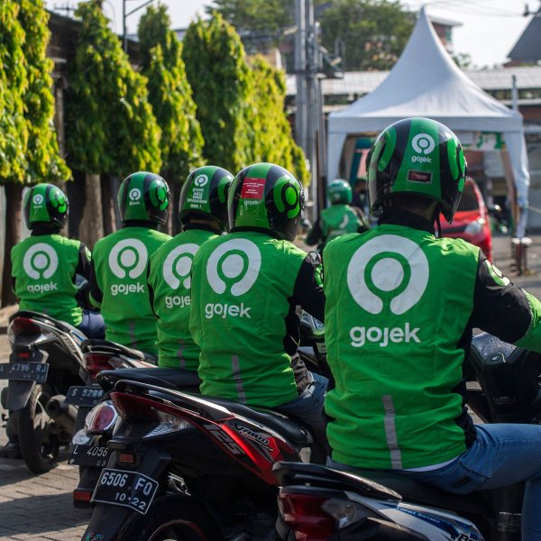 Gojek riders wait for their delivery orders at a distribution centre in Surabaya on May 17, 2021, as Gojek and Tokopedia unveiled a merger to form GoTo Group, creating the largest tech firm in the world's fourth most populous country.