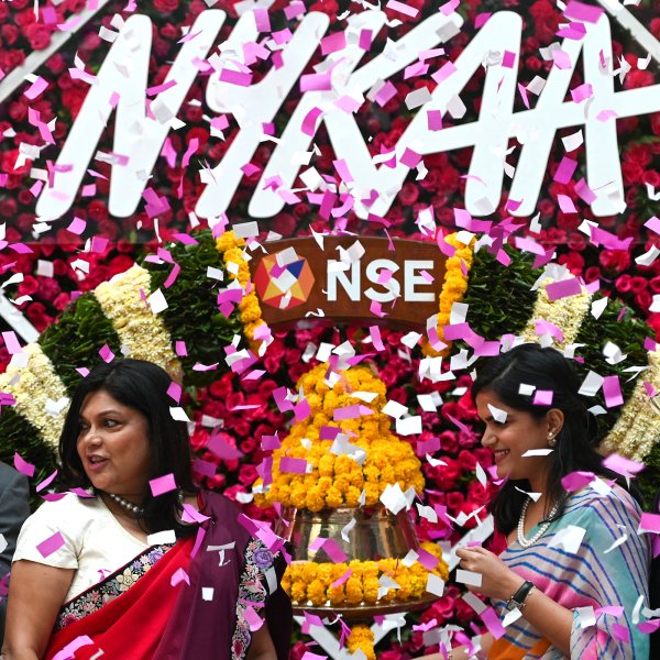 Falguni Nayar (C-L), managing director and CEO of Nykaa, an online marketplace for beauty and wellness products, along with her daughter Advaita (C-R) attends the company's IPO listing ceremony at the National Stock Exchange in Mumbai on November 10, 2021.