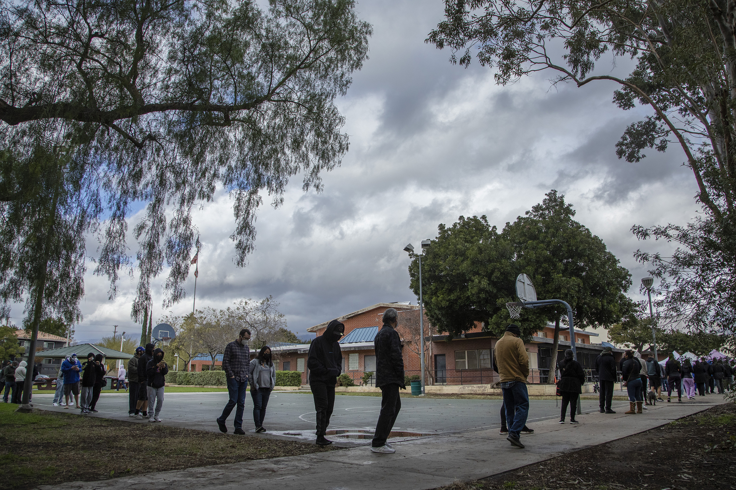 People wait in line for COVID-19 testing at San Fernando Recreation Park on Monday, Dec. 27, 2021. In L.A. County, new coronavirus cases are dramatically increasing (Myung J. Chun—Los Angeles Times/Getty Images)