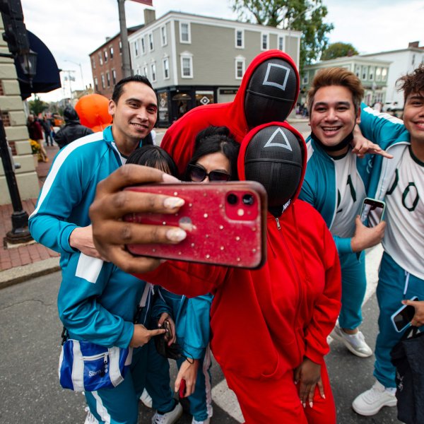 A group dressed as characters from the Netflix show  Squid Game  pose for a 'selfie' on Halloween in Salem, Massachusetts on October 31, 2021.