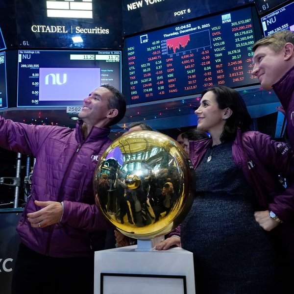 Nubank CEO David Velez, left, takes a selfie photo with his company's co-Founders Cristina Junqueira, and Edward Wible, before he rings the ceremonial first trade bell during his IPO, on the New York Stock Exchange trading floor, Thursday, Dec. 9, 2021.