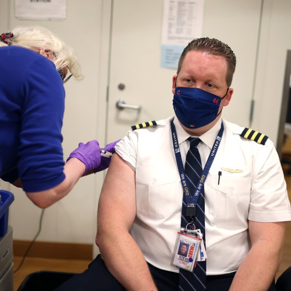 United Airlines pilot Steve Lindland receives a COVID-19 vaccine from RN Sandra Manella at United's onsite clinic at O'Hare International Airport on March 09, 2021 in Chicago, Illinois.