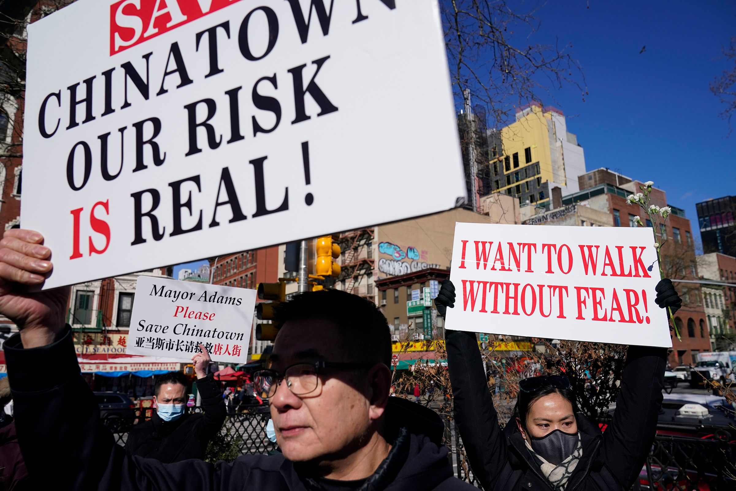 People hold signs during a rally in response to the killing of Christina Yuna Lee in New York, Feb. 14, 2022. (Seth Wenig—AP)