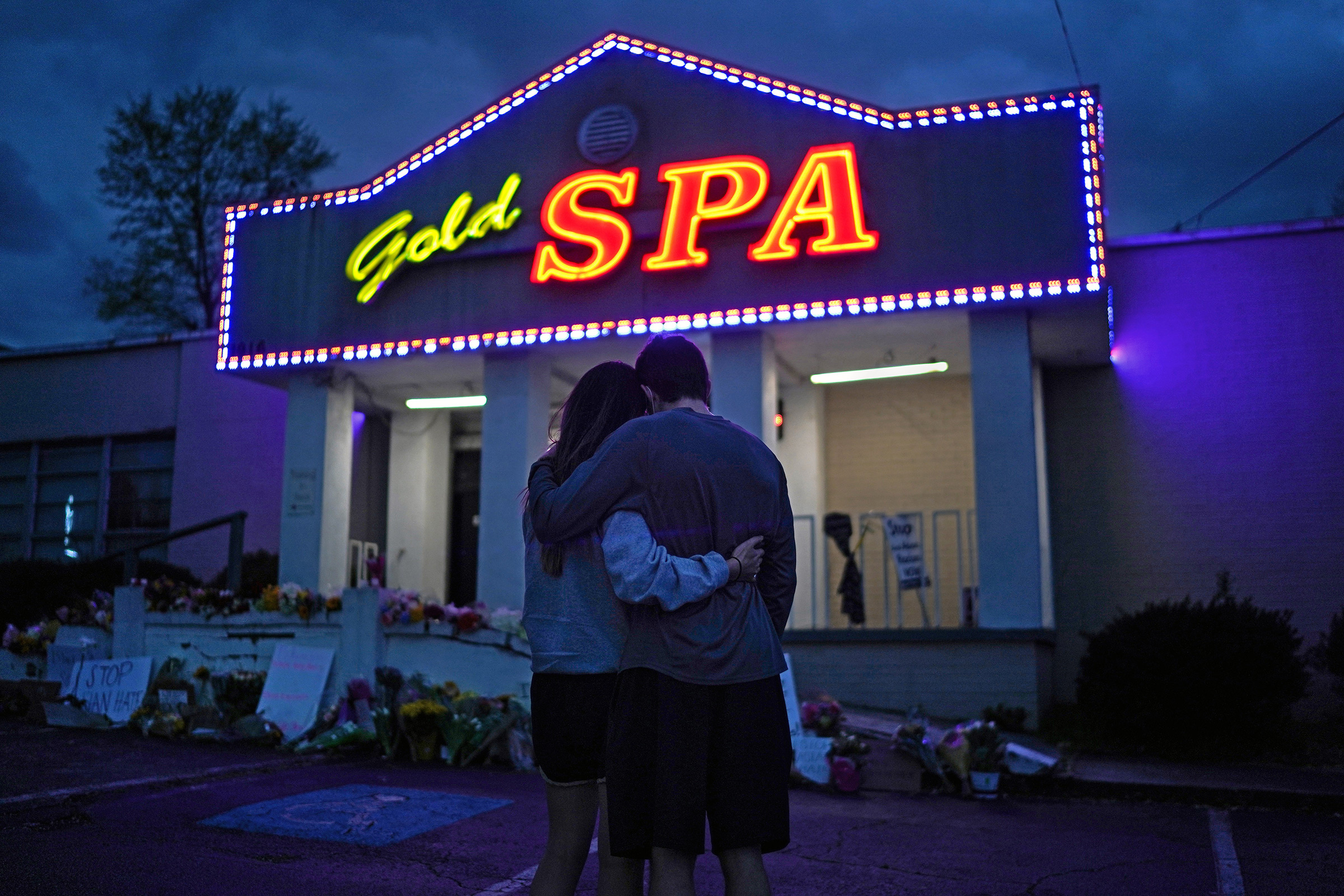 Cynthia Shi embraces her boyfriend, Graham Bloomsmith, outside Gold Spa in Atlanta, one of three massage businesses where a gunman killed eight people, on March 18, 2021.