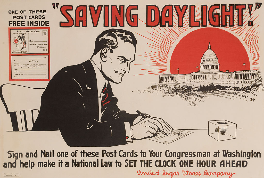 An illustration of a businessman writing a card to his Congressman offering his support of Daylight Saving Time in a circa 1917 poster produced by the United Cigar Stores Company. (David Pollack/Corbis—Getty Images)