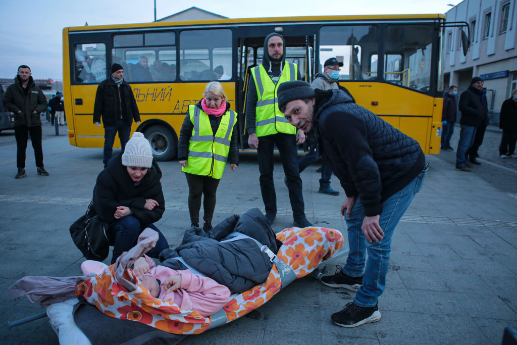 Volunteers stand around a disabled person in a stretcher after the arrival of an evacuation train from Kramatorsk, Donetsk Region, arrived at the railway station, Lviv, western Ukraine. (Alona Nikolaievych—Ukrinform/NurPhoto/ Getty Images)
