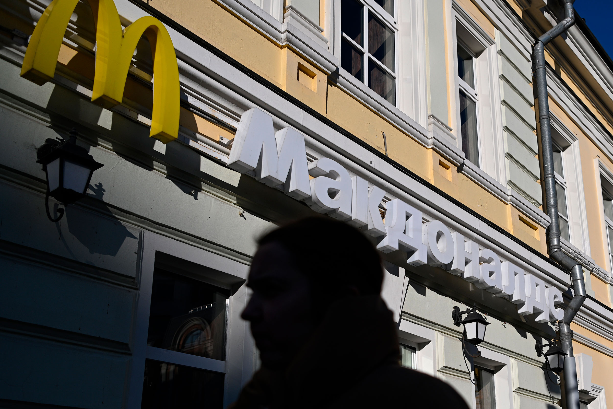 A person passes by a McDonald's restaurant, in Moscow, Russia (Pavel Bednyakov—Sputnik/AP)