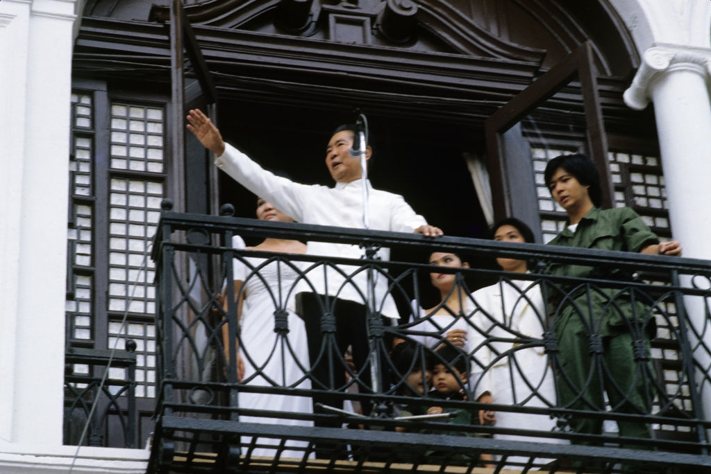 The late President Ferdinand Marcos waves goodbye to supporters from the balcony of Malacañang Palace in Manila following his oath-taking ceremony as victor in the Philippine Presidential snap elections, Feb. 25 1986. Beside him stand the First Lady Imelda Marcos, and their children, including his son and namesake, Ferdinand "Bongbong" Marcos Jr. This was the last public appearance by Marcos and his family before leaving for exile in Hawaii. (Alex Bowie—Getty Images)