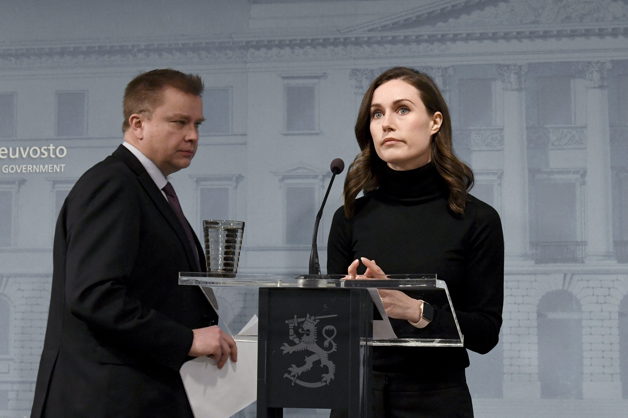 Finland's Prime Minister Sanna Marin, right, and Defense Minister Antti Kaikkonen arrive to address a press conference after the decision to supply arms to Ukraine, in Helsinki, Finland, on Feb. 28, 2022.
