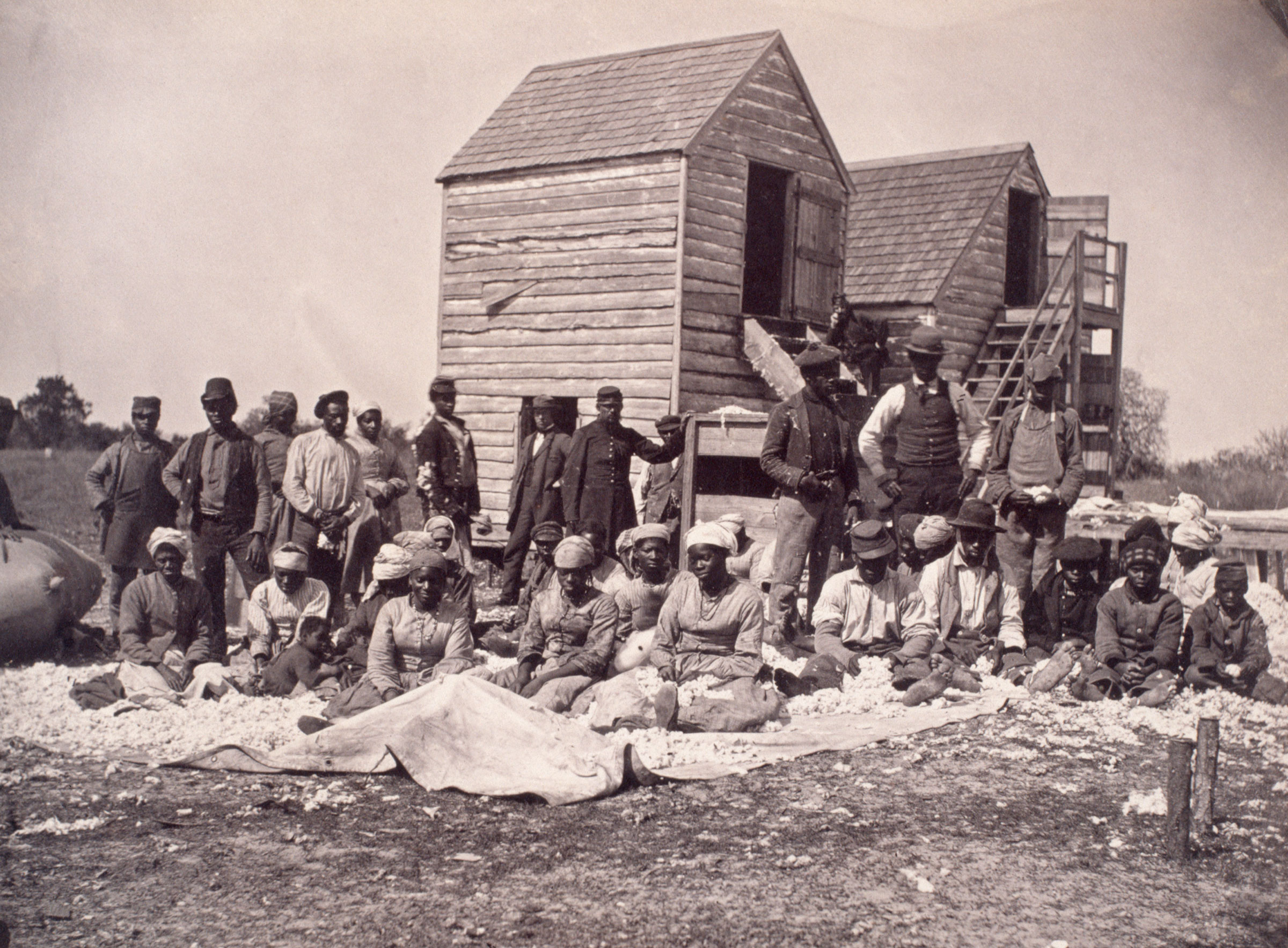 A group of escaped slaves that gathered on the former plantation of Confederate General Thomas Drayton. After Federal troops occupied the plantation these former slaves began to harvest and gin cotton for their own profit, circa 1862. (Corbis/Getty Images)