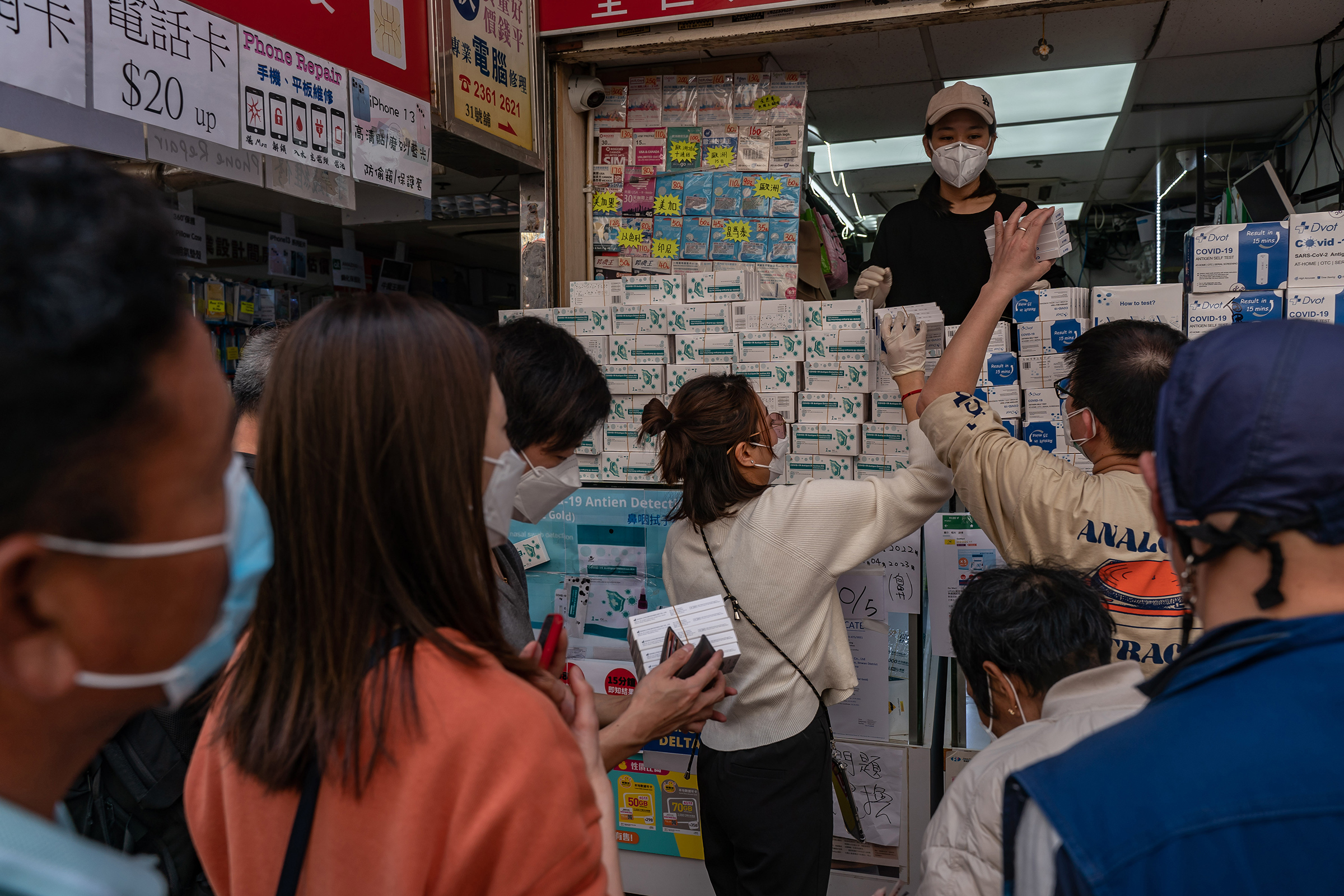 Customers purchase Covid-19 rapid antigen test kits from a store on March 1 in Hong Kong (Anthony Kwan—Getty Images)