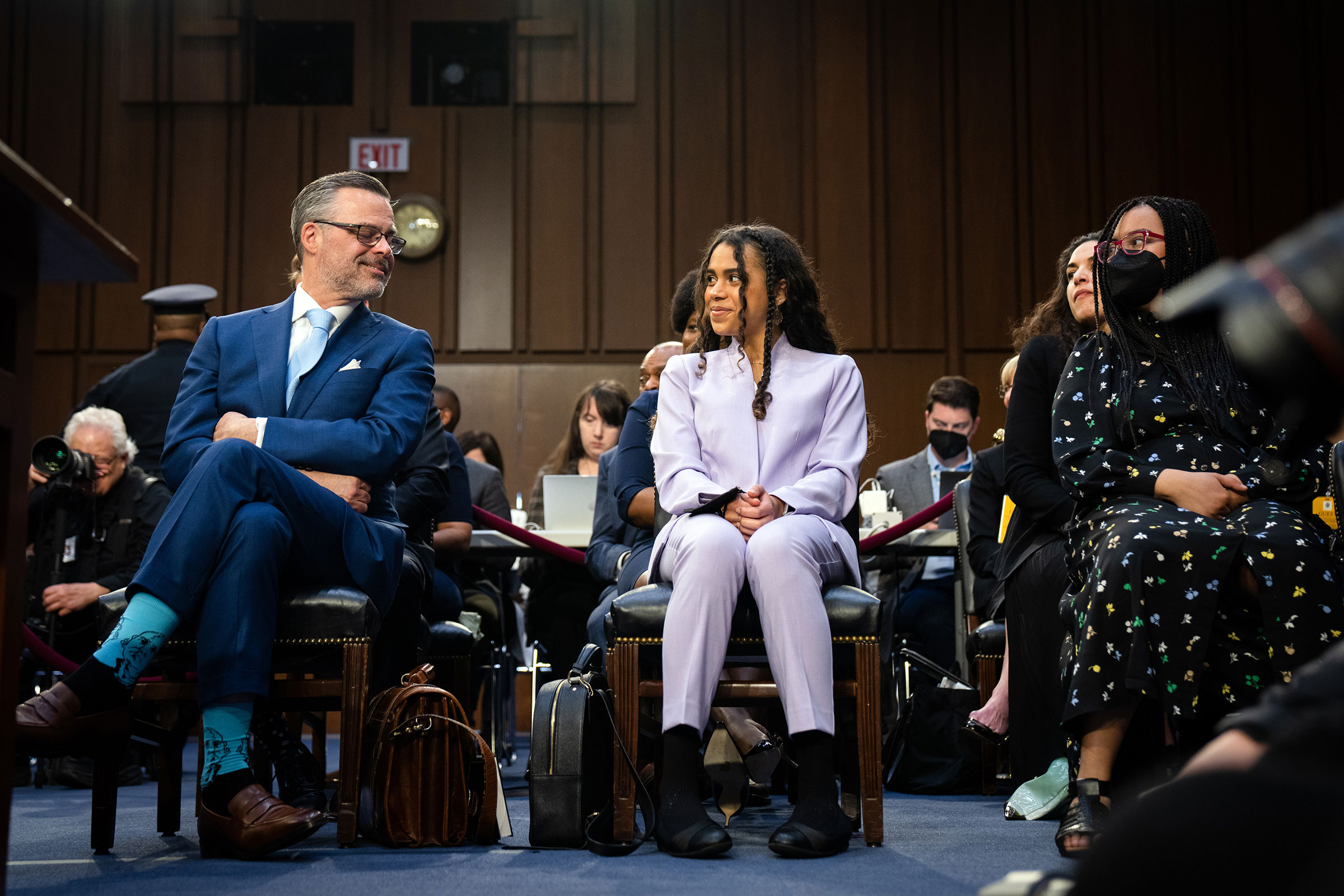Leila Jackson, center, and Talia Jackson, right, look at their father Patrick Jackson during the hearing on March 21. Jackson gave her daughters a special message during her opening statement that day: "Girls, I know it has not been easy as I have tried to navigate the challenges of juggling my career and motherhood. And I fully admit that I did not always get the balance right," she said. "But I hope that you have seen that with hard work, determination, and love, it can be done." (Sarahbeth Maney—The New York Times/Redux)
