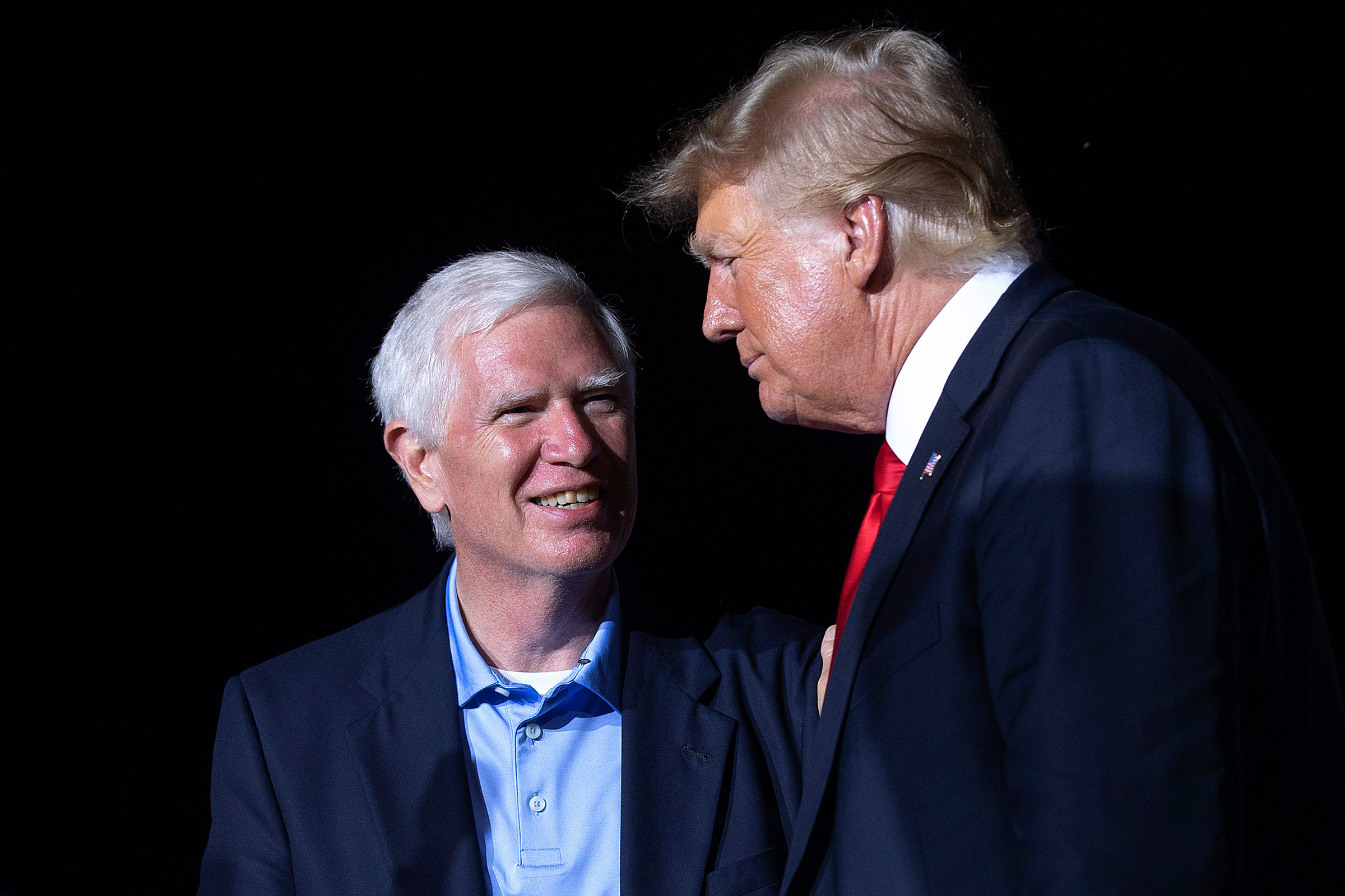 Former President Donald Trump welcomes candidate for Senate and Rep. Mo Brooks to the stage during a "Save America" rally at York Family Farms on in Cullman, Ala. on Aug. 21, 2021. (Chip Somodevilla—Getty Images)