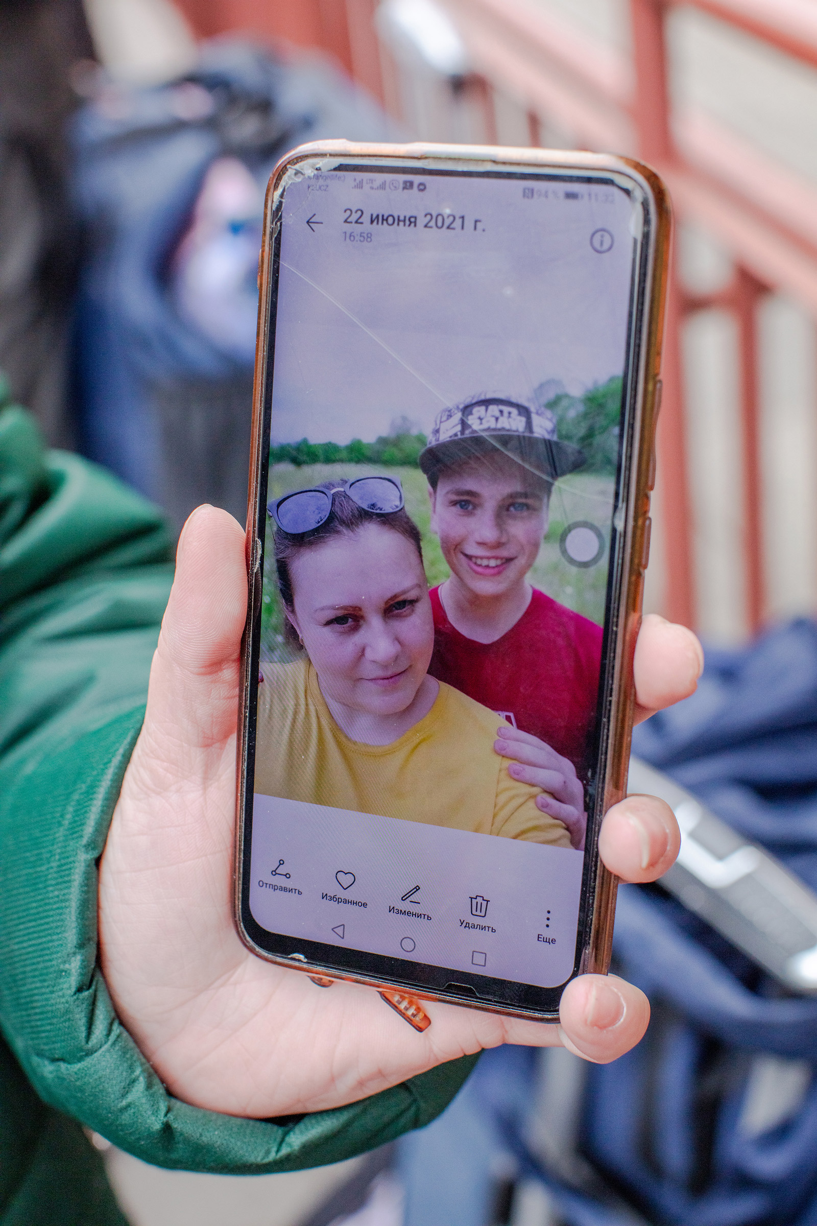 Anna Abramosova shows a photo of herself with one of her teenage sons, on March 1, ahead of returning to eastern Ukraine (Natalie Keyssar for TIME)
