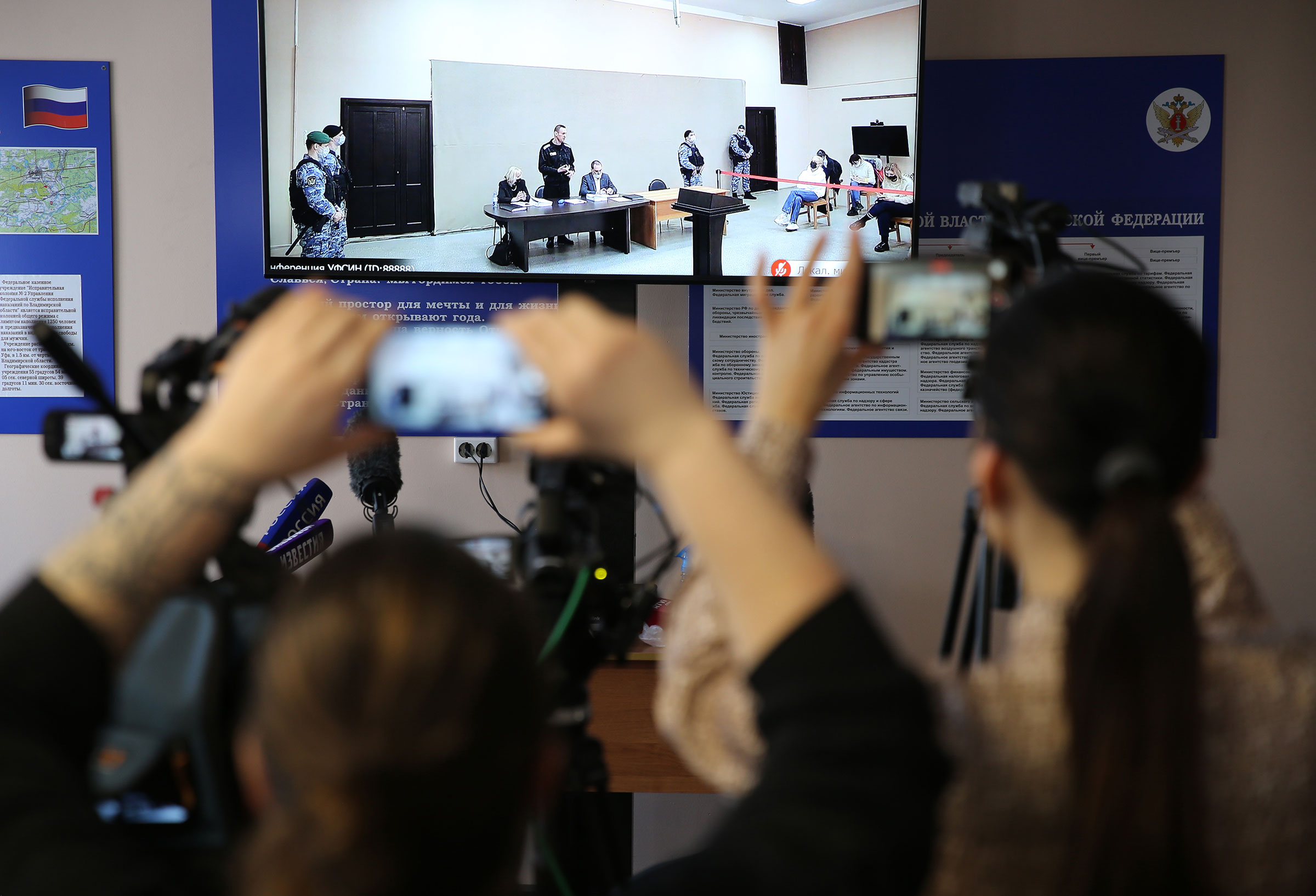 Members of the media take photographs of the screen showing Russian opposition politician Alexei Navalny at the penal colony during the trial in Pokrov, Vladimir region, Russia on Feb. 15, 2022. (Mikhail Svetlov—Getty Images)