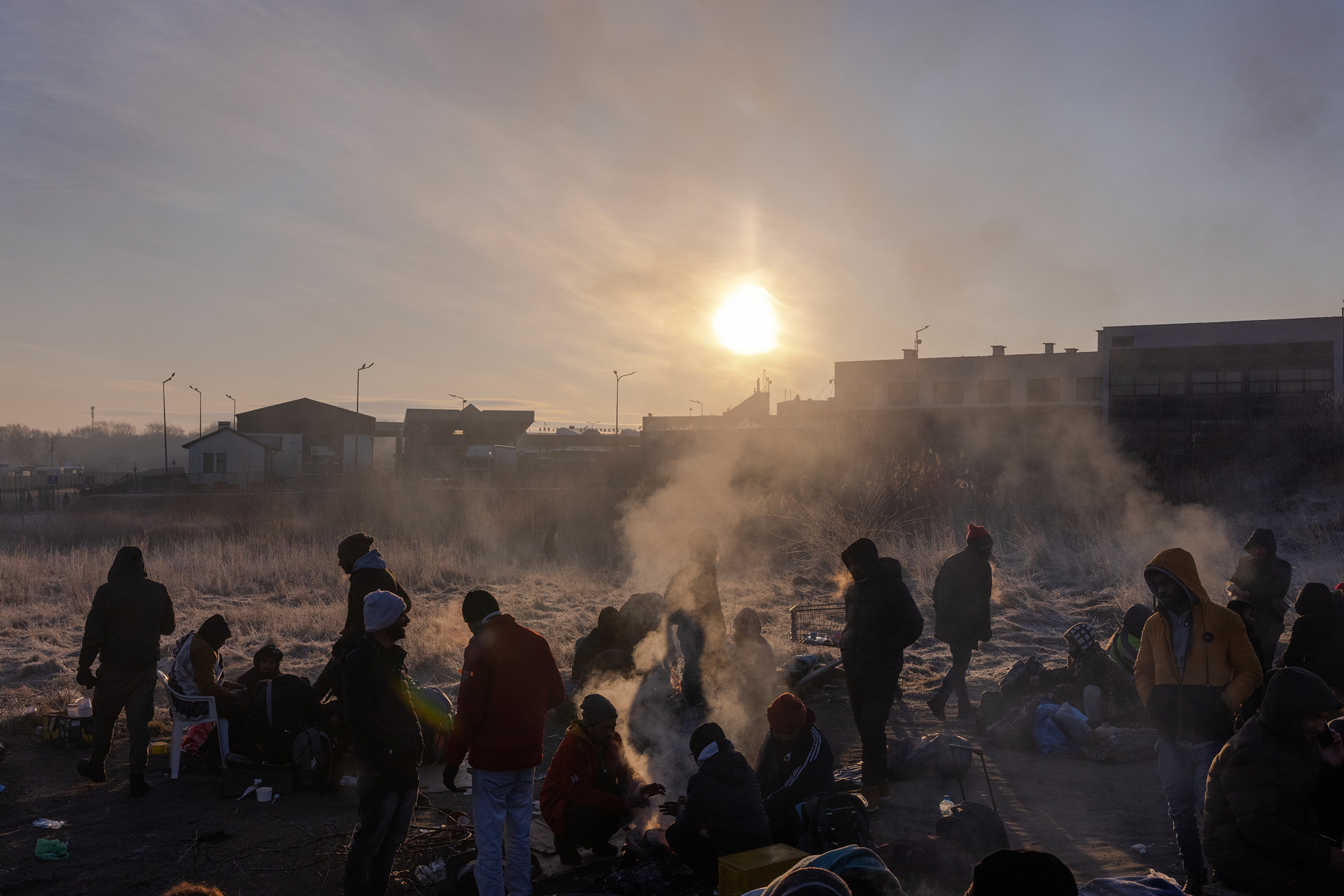 Refugees wake after sleeping on blankets and cardboard on the ground on the Polish side of the Medyka crossing, on March 1. (Natalie Keyssar for TIME)