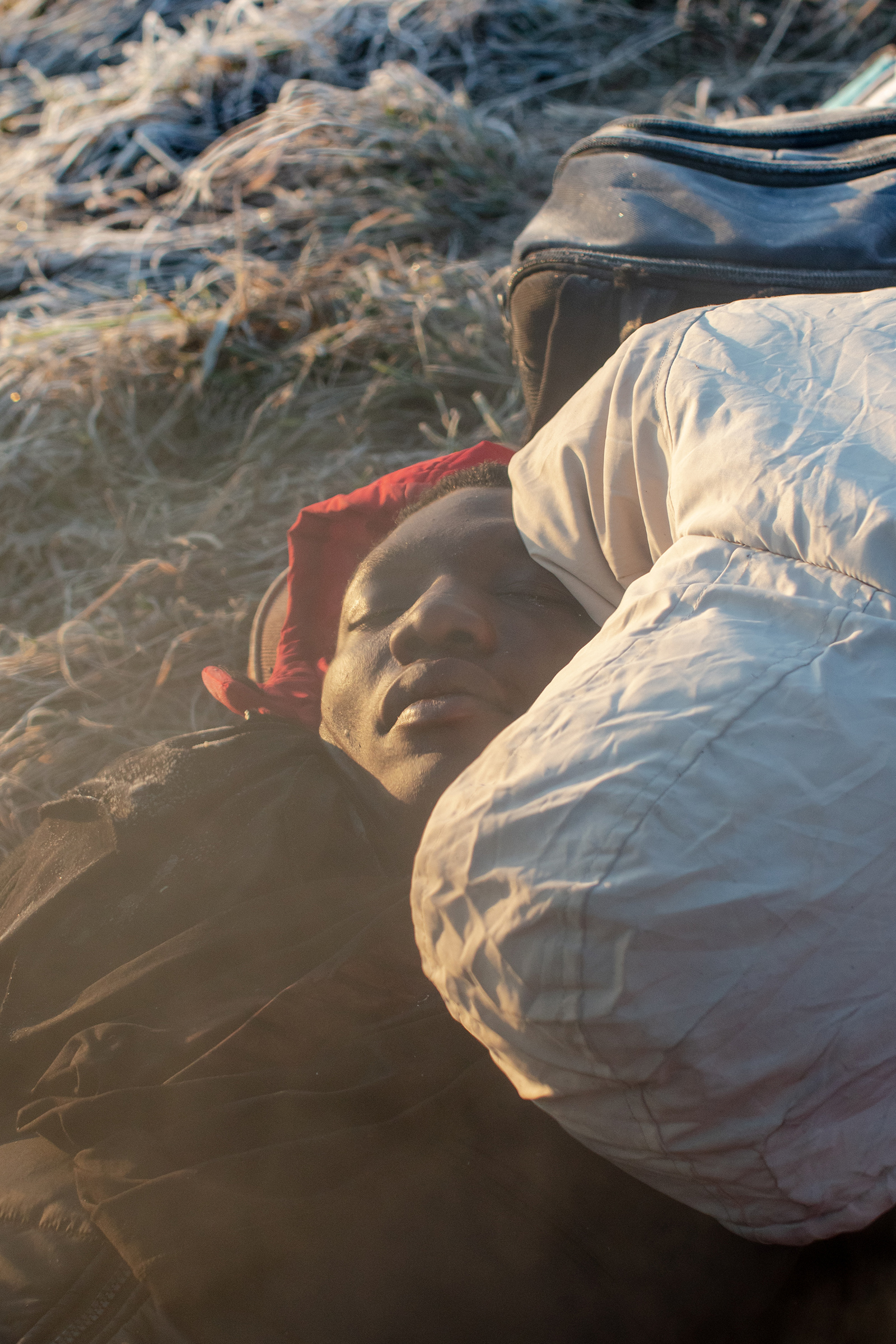 Refugees sleep on the cold ground on the morning of March 1 on the Polish side of the Medyka crossing (Natalie Keyssar for TIME)