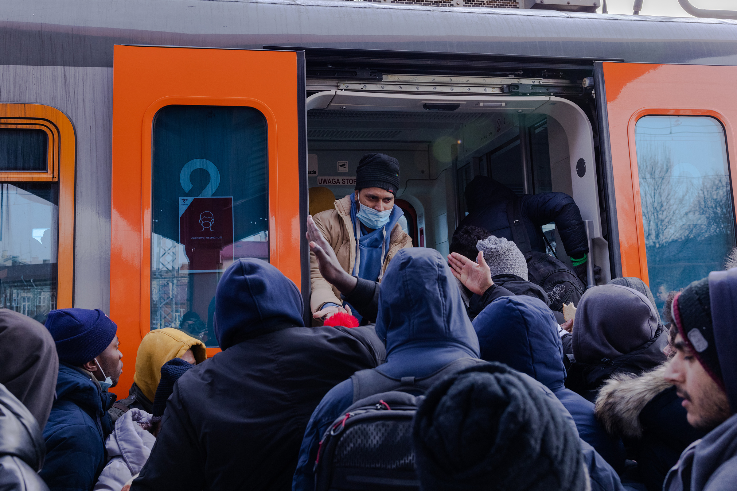 Refugees at the Przemysl train station attempt to board a crowded train to Krakow on March 1. (Natalie Keyssar for TIME)