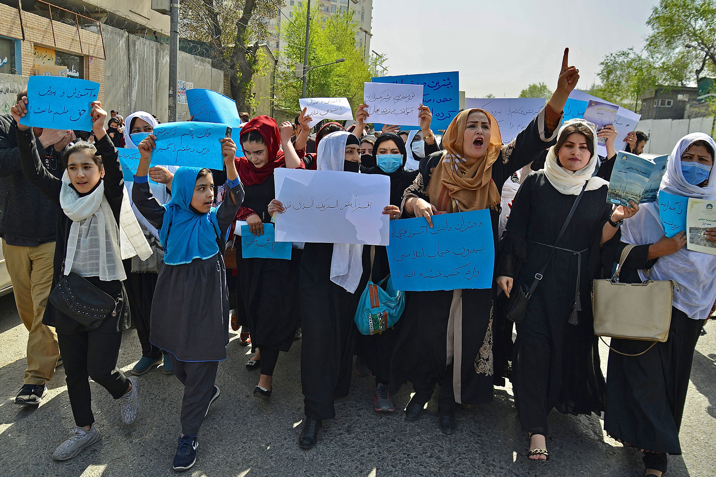 Afghan women and girls protest in front of the Ministry of Education in Kabul demanding that high schools be reopened for girls, on March 26, 2022.