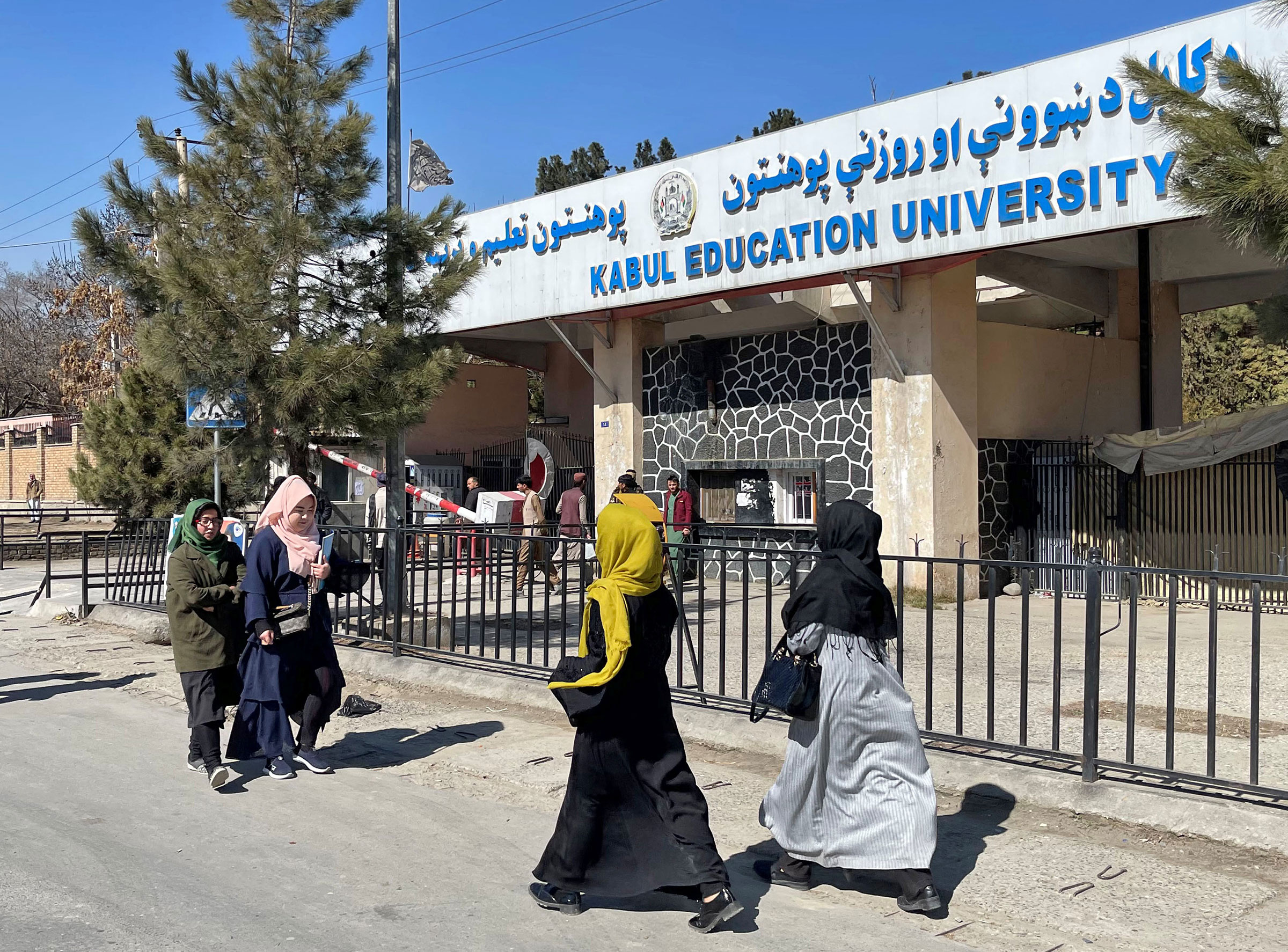 Female students walk in front of the Kabul Education University in Kabul, Feb. 26, 2022.