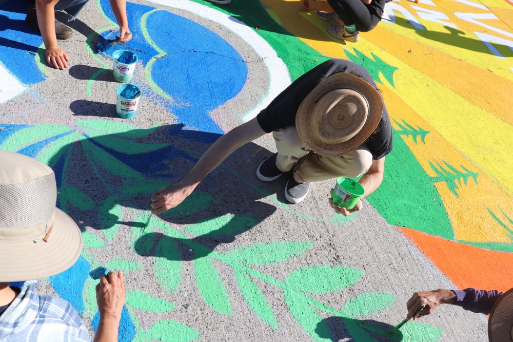 Members of the Sunrise Movement create a mural at a protest outside Nancy Pelosiâ€™s San Francisco home in June 2021.