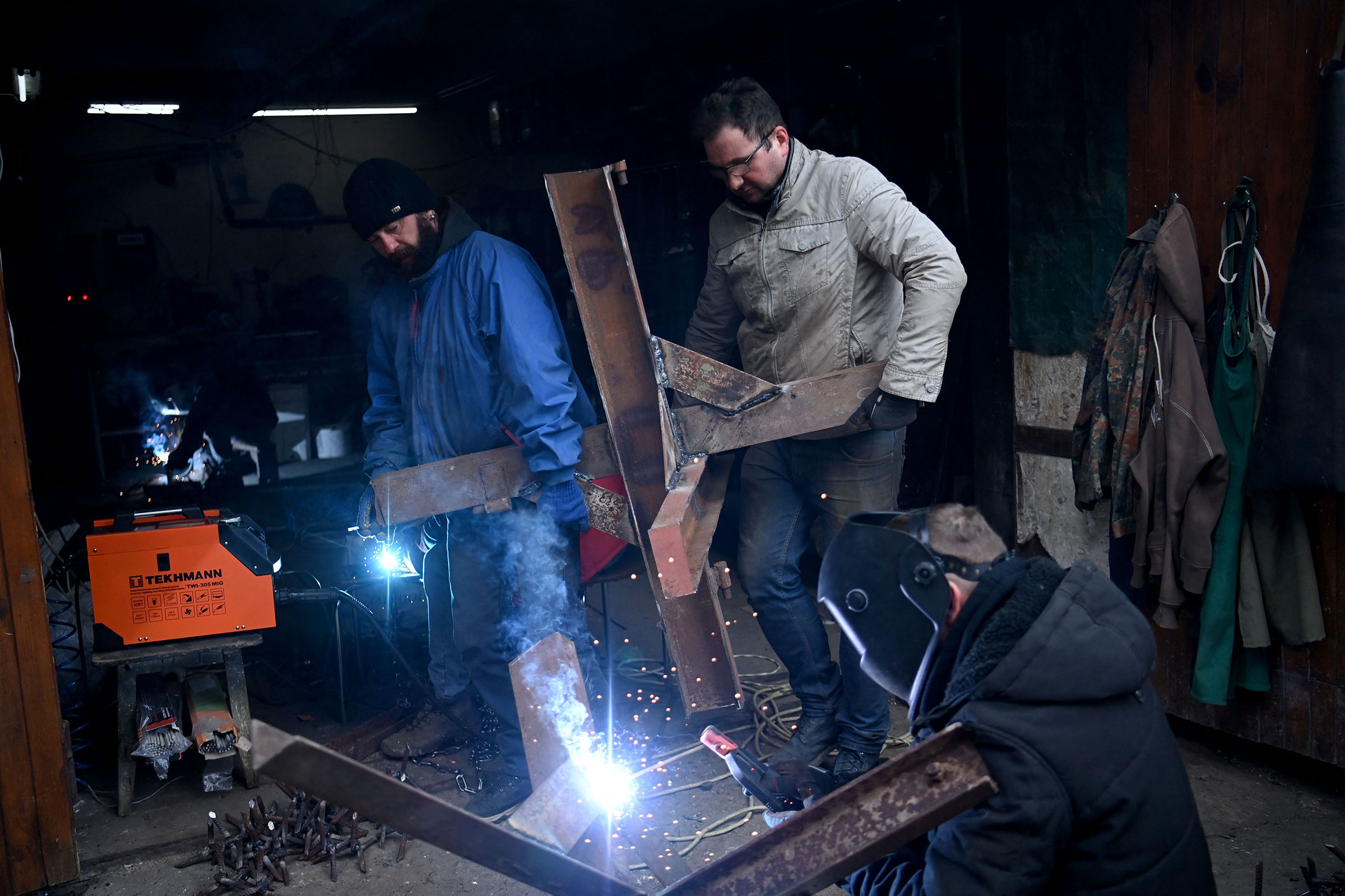 Volunteers solder anti-tank obstacles known as Czech hedgehogs in a workshop in Lviv on March 3.