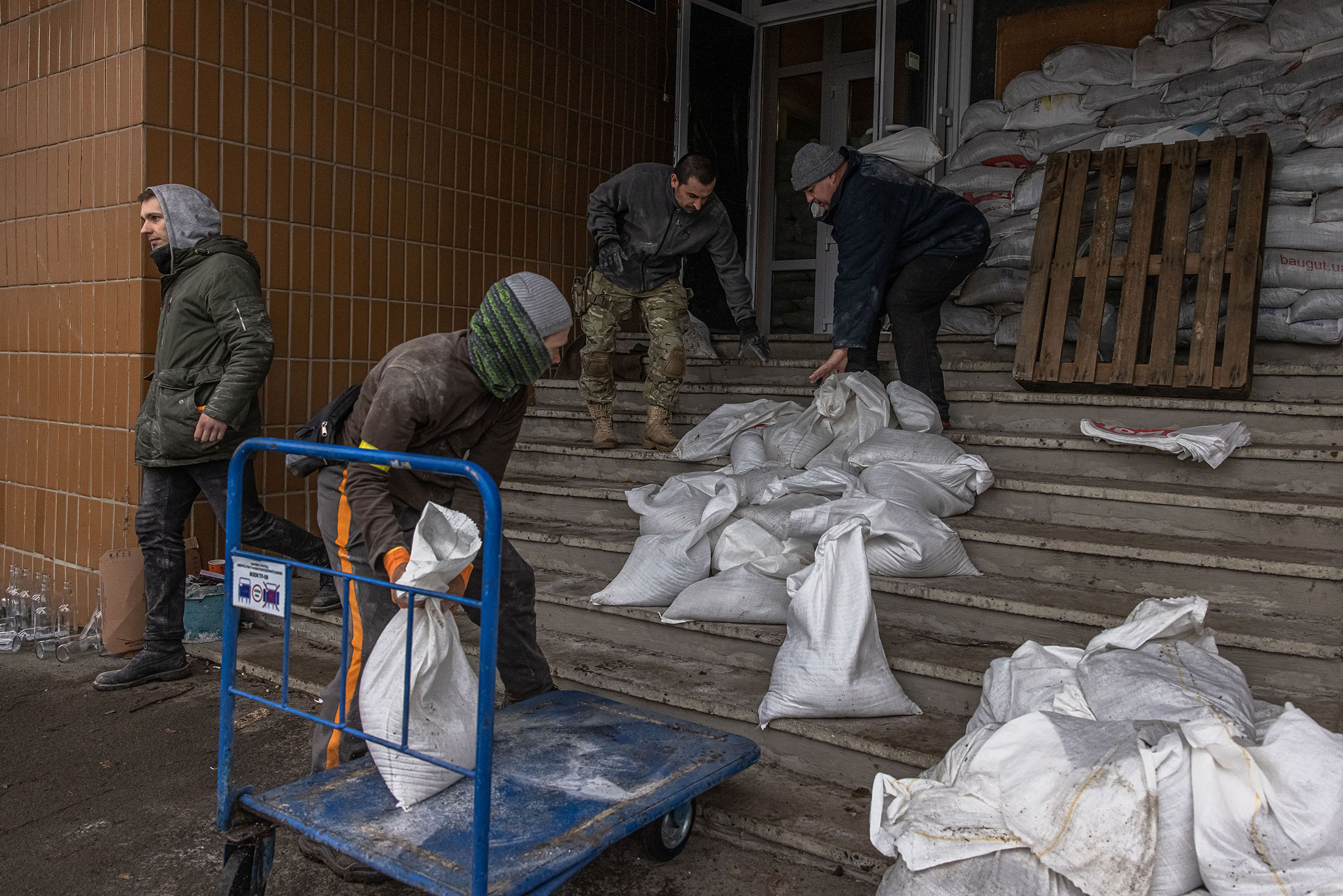 Members of Ukrainian Territorial Defense Forces barricade an entrance to their base, in Kyiv on March 2.
