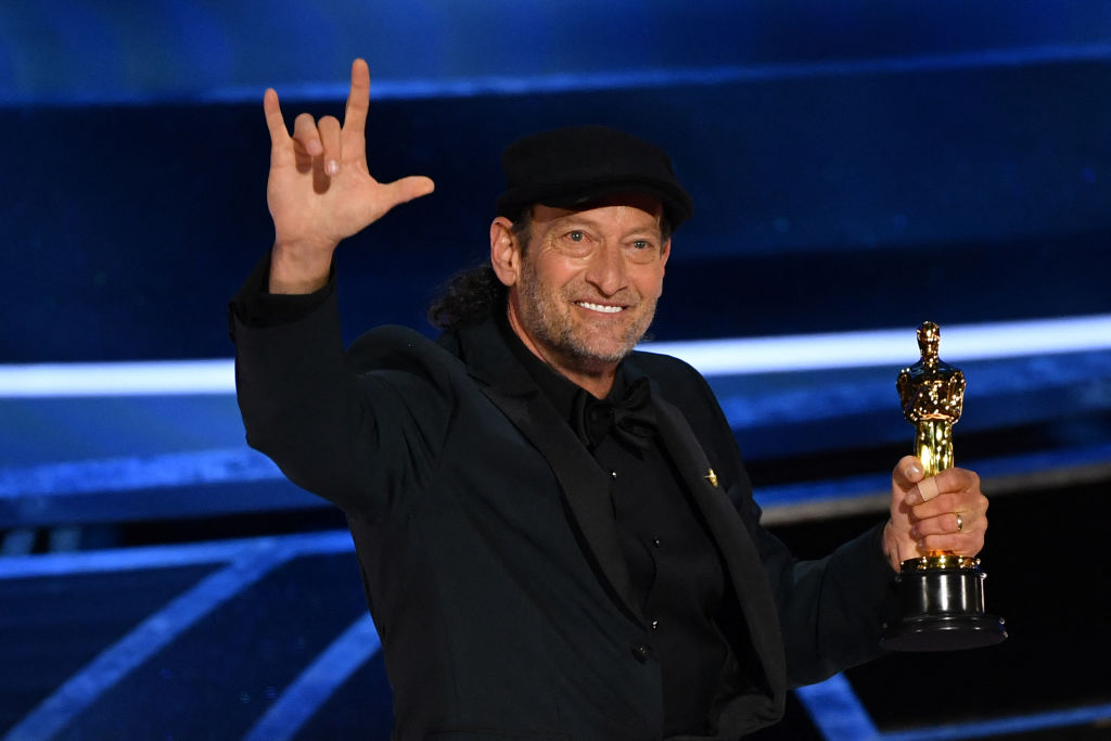 Troy Kotsur accepts the award for Best Actor in a Supporting Role for "CODA" during the 94th Oscars (AFP via Getty Images)