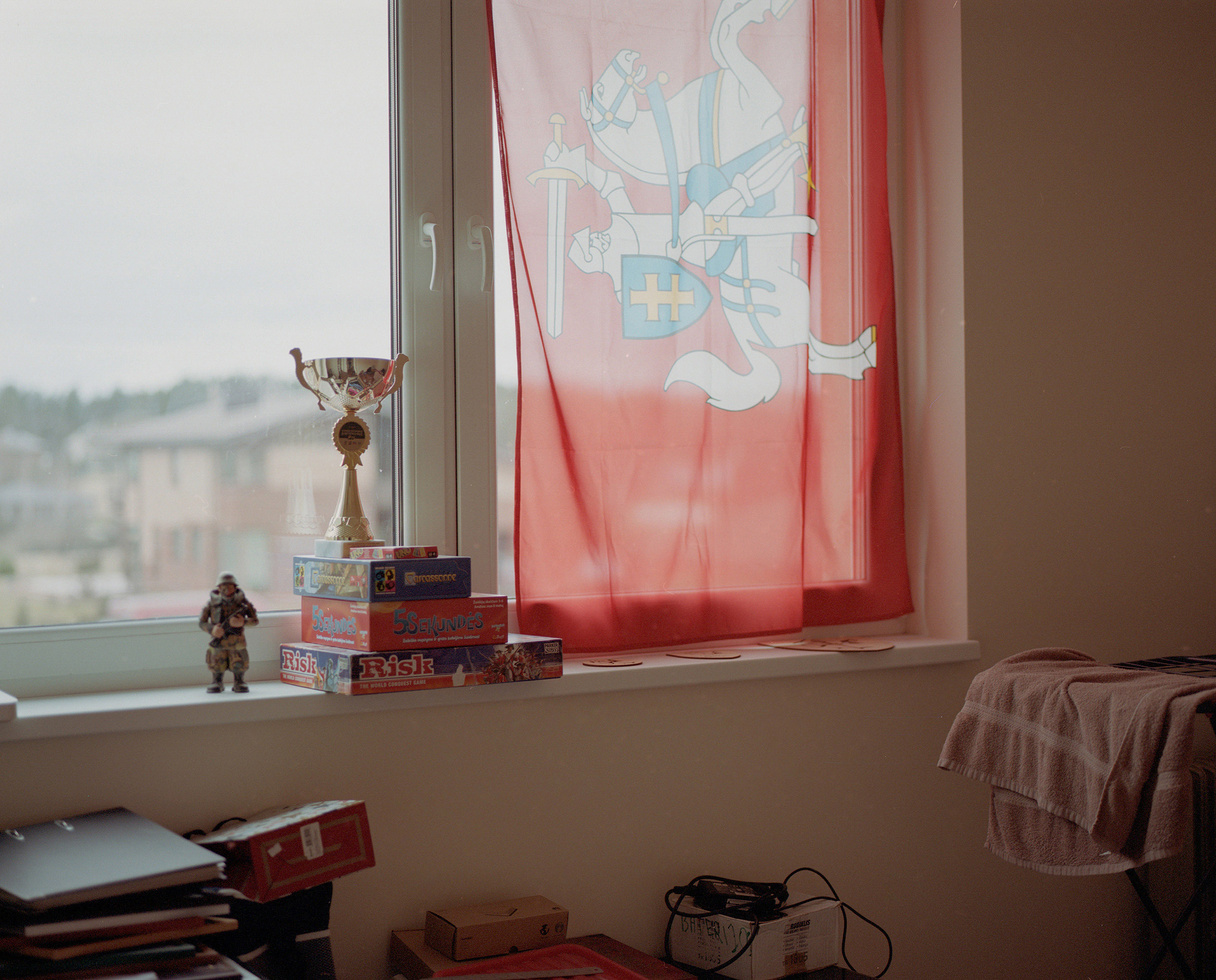 Gintautas' training centre window is decorated with Historic Lithuanian National flag next to which stands toy soldier figurine and his personal wining cup. Kaunas, Lithuania.