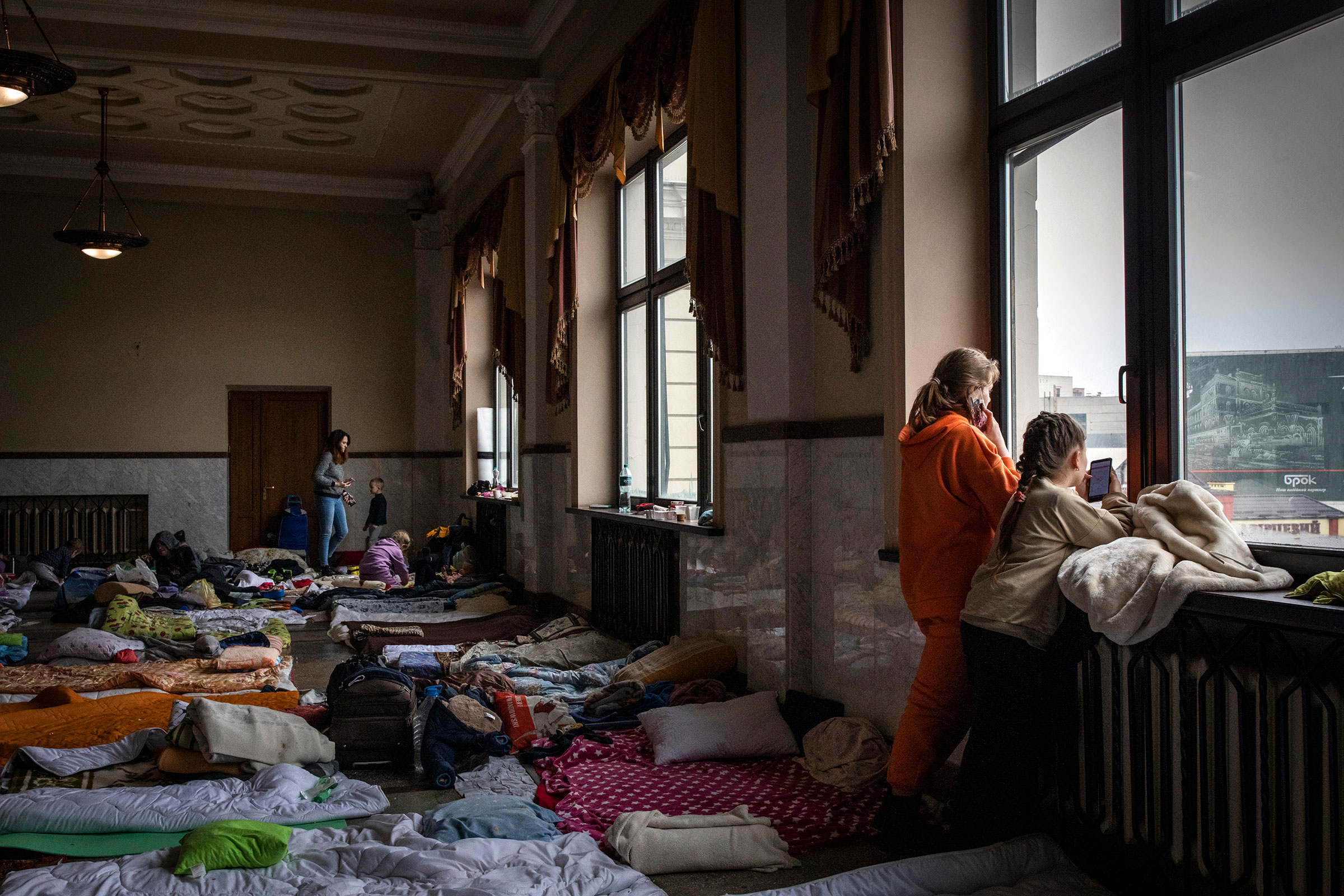 Women and children, many of them from the besieged city of Kharkiv in eastern Ukraine, shelter in a waiting hall at the train station in Lviv on March 7. (Ivor Prickett—The New York Times/Redux)