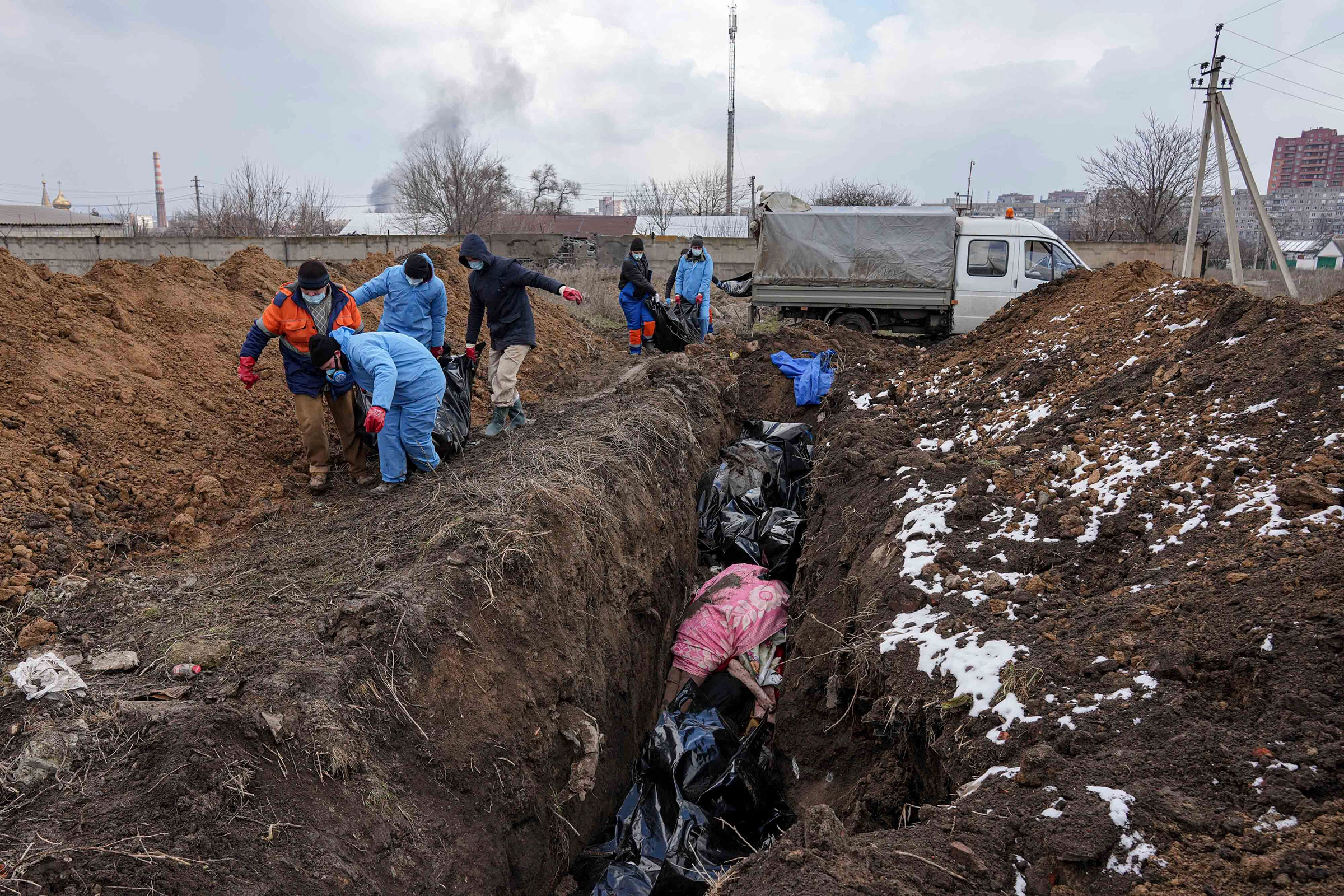 Dead bodies are put into a mass grave on the outskirts of Mariupol on March 9 as people cannot bury their dead because of the heavy shelling by Russian forces.