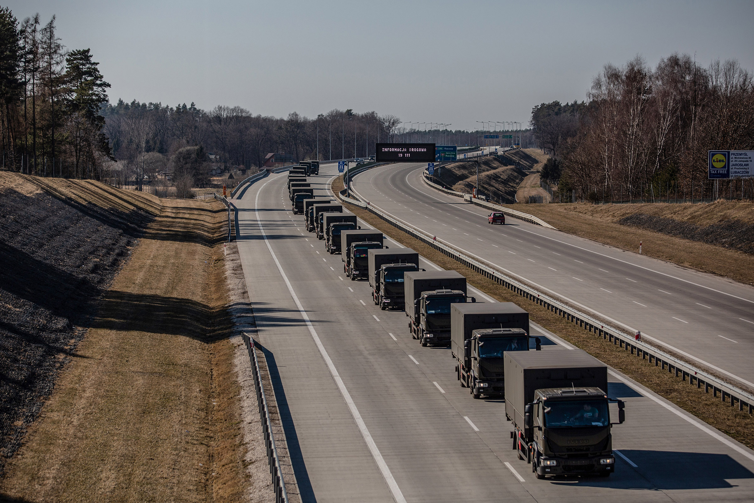 A convoy of unmarked trucks carrying supplies for Ukraine passes through Korczowa, Poland, on March 17