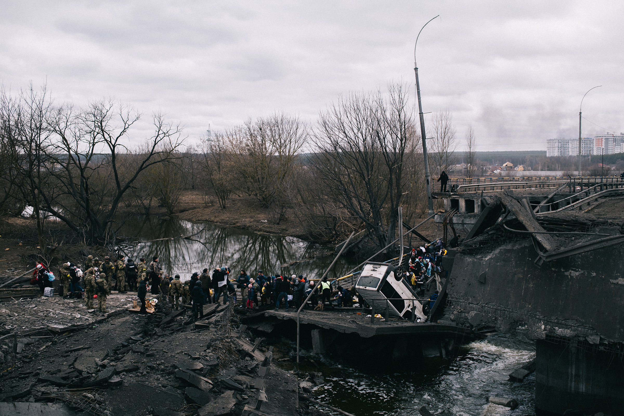 Civilians cross the Irpin river, near Kyiv, on March 5, where a bridge was destroyed by the Ukrainian army to stop Russian forces from advancing (Maxim Dondyuk)