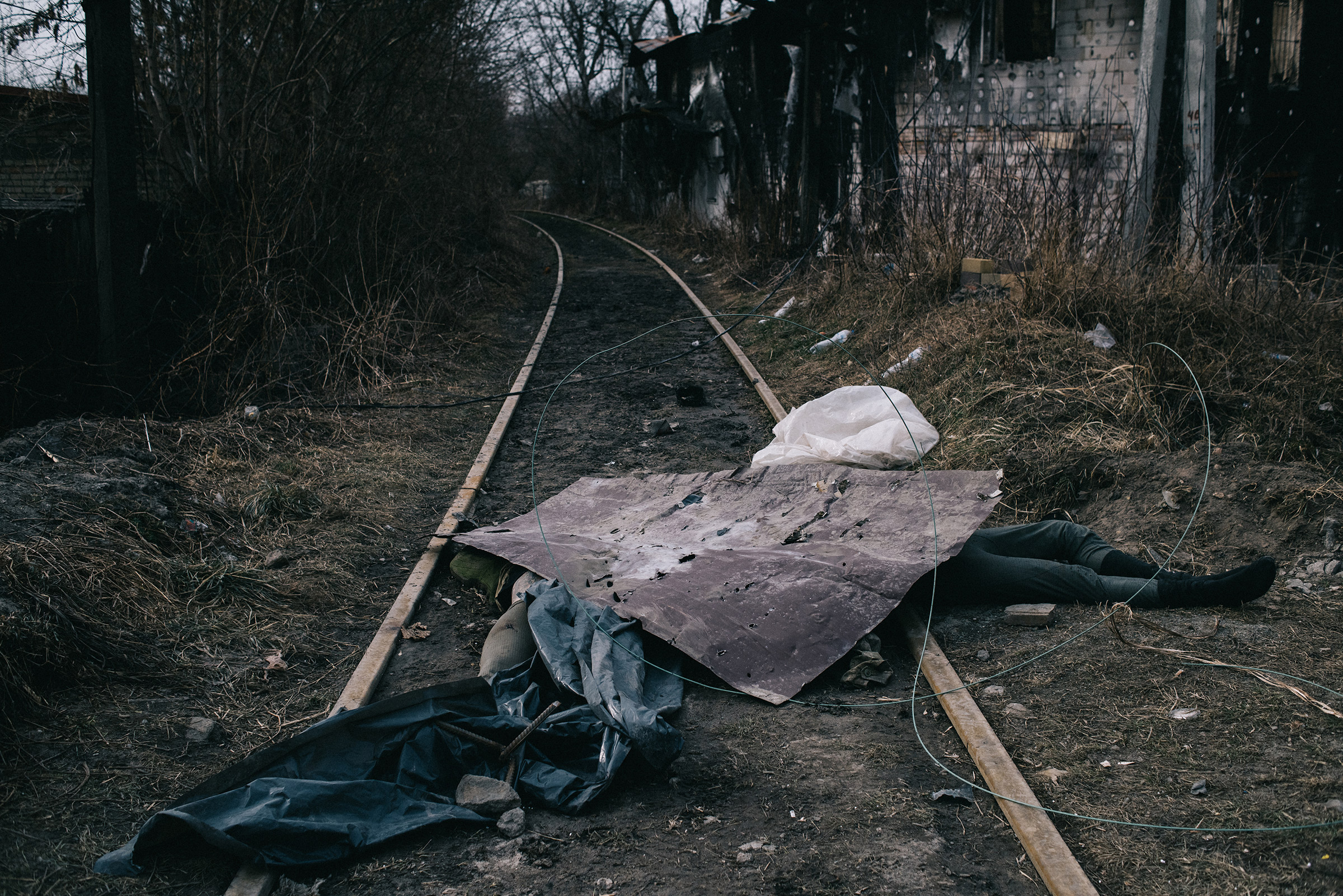 A Russian soldier lies dead on a railroad track in Irpin, northwest of Kyiv, on March 12. Ukrainian forces have repelled wave after wave of Russian attacks on the town, a gateway to the capital