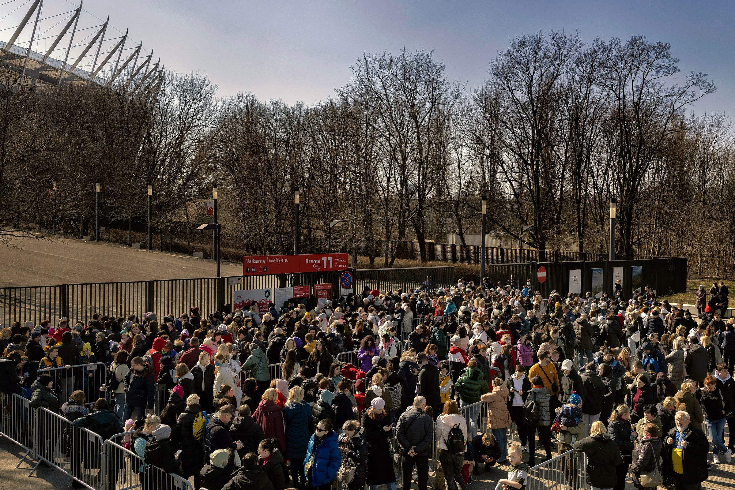 Refugees from Ukraine wait in line for identification documents outside the National Stadium in Warsaw, Poland, on March 21. (Maciek Nabrdalik—The New York Times/Redux)