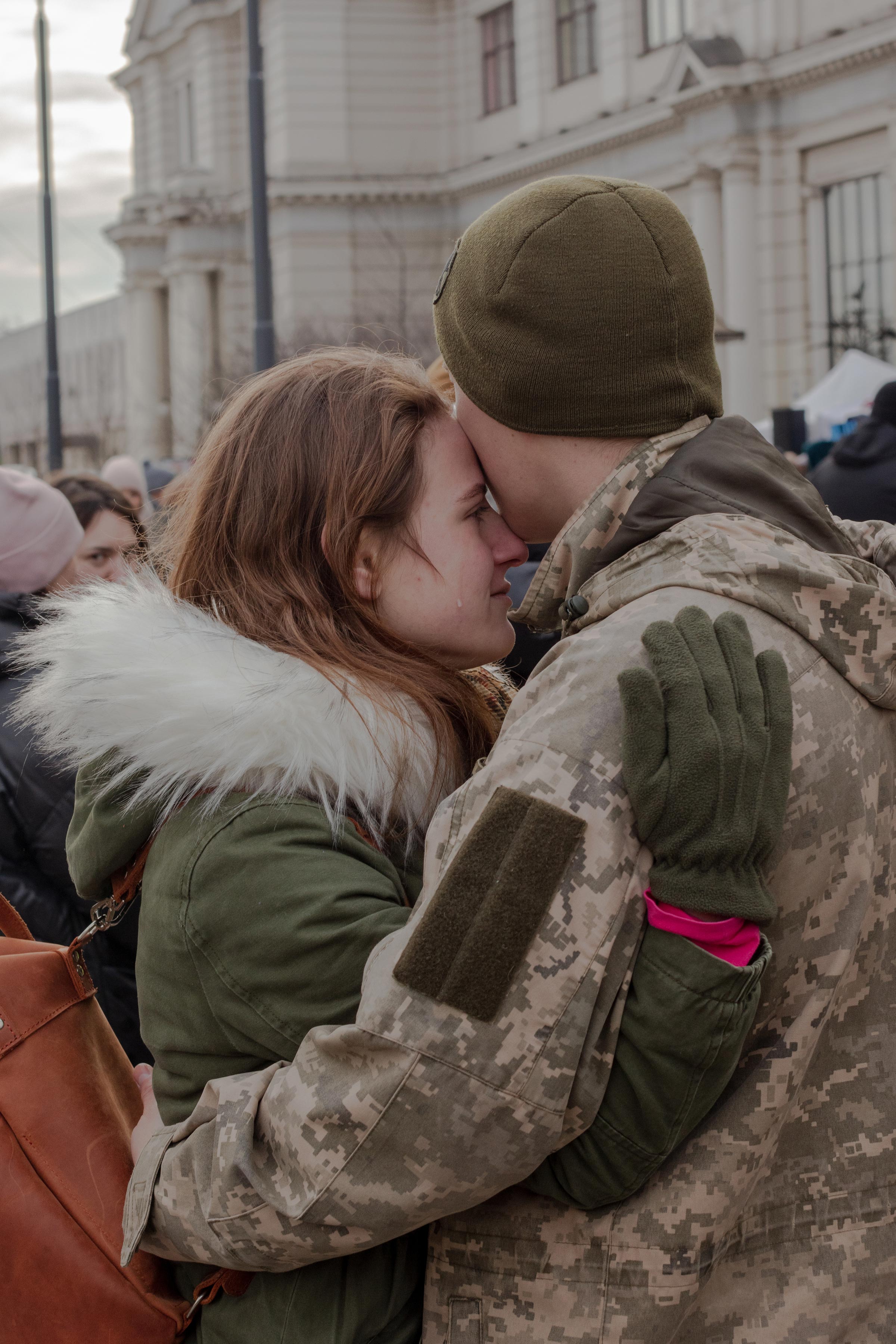 Soldiers say emotional goodbyes to their partners at the Lviv train station before heading to the front lines on March 8. (Natalie Keyssar for TIME)