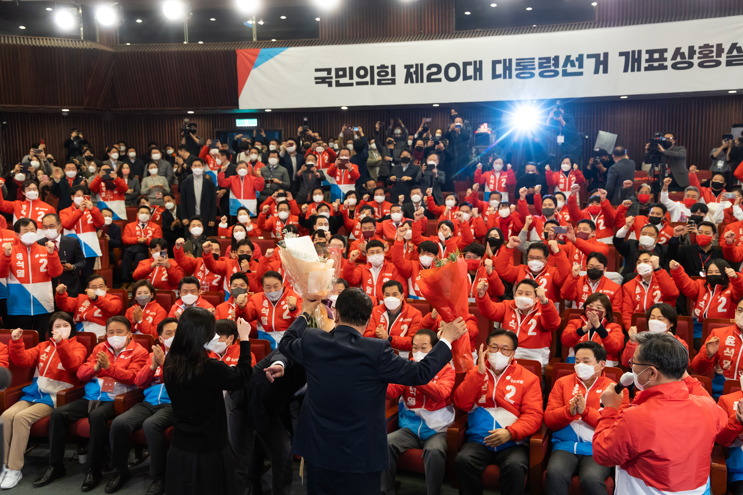 Yoon, South Korea's president-elect and holding a bouquet, speaks at his campaign office in the National Assembly. The former top prosecutor won the election as South Korea's president, returning the conservative opposition to power after five years (SeongJoon Cho—Bloomberg/Getty Images)