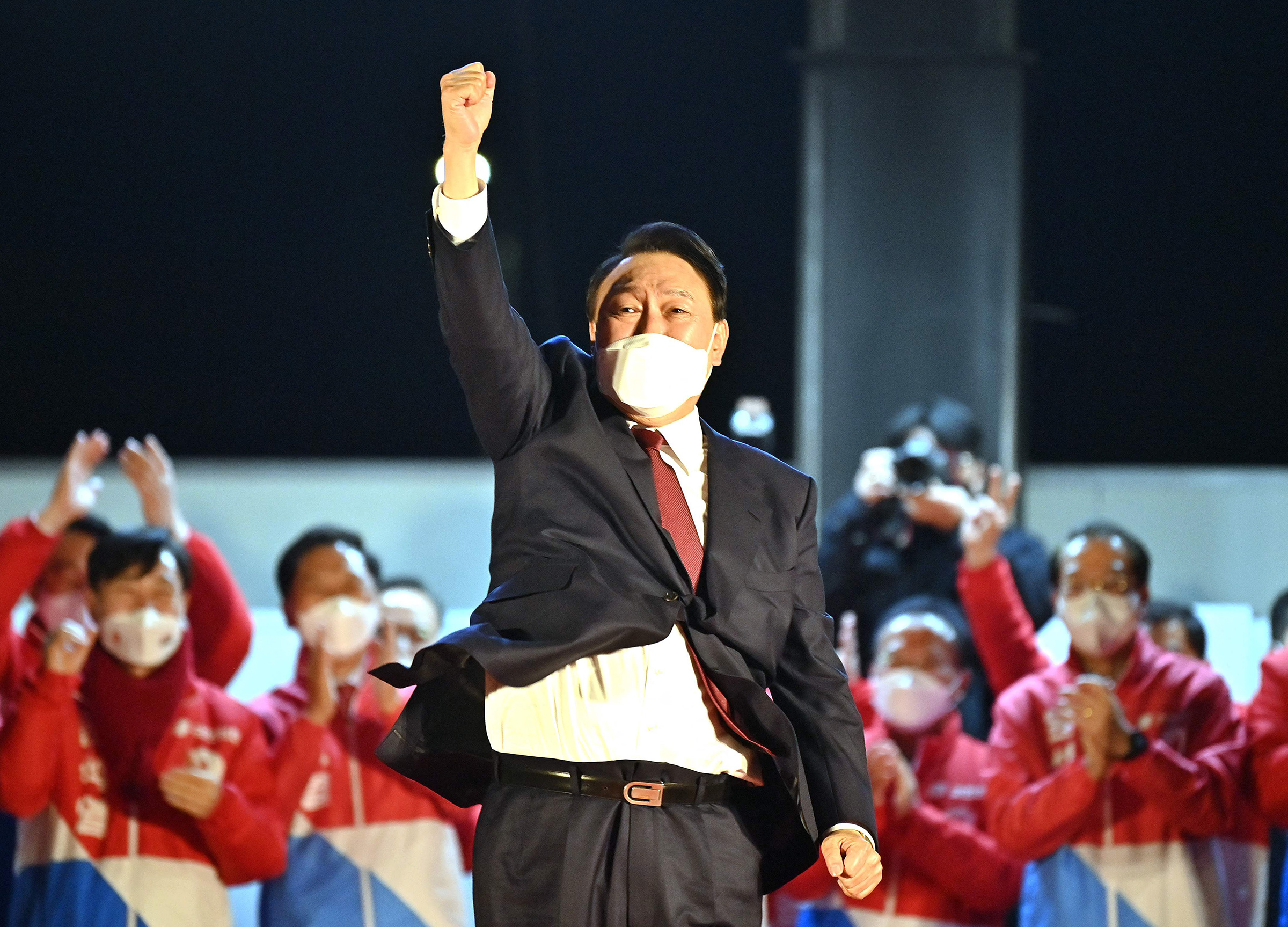 South Korea's new president-elect Yoon Suk Yeol, of the People Power Party, gestures to his supporters as he is congratulated outside the party headquarters in Seoul on March 10, 2022. (Jung Yeon-je—AFP/Getty Images)