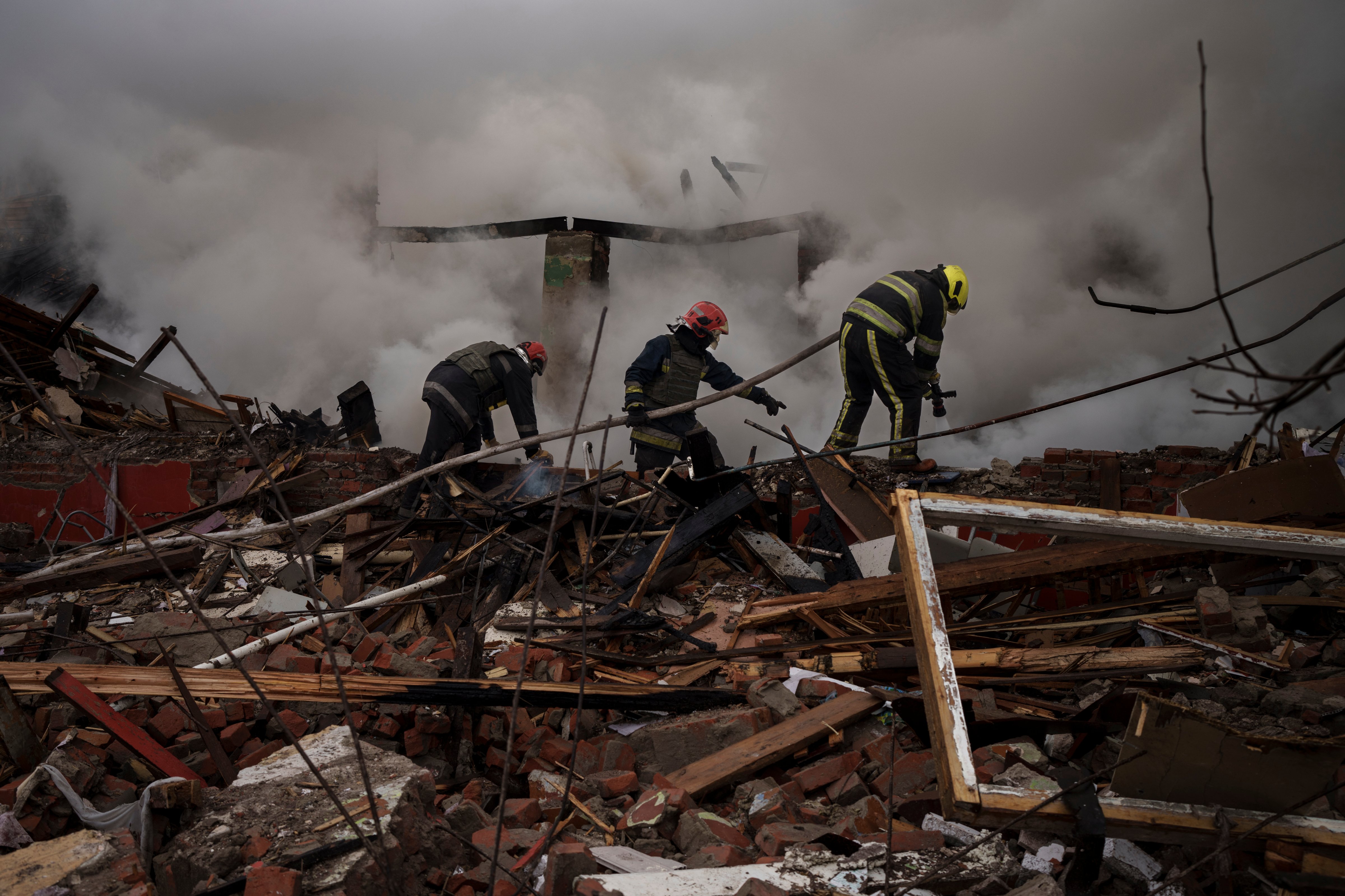 Firefighters work to extinguish a fire after a Russian attack destroyed a culinary school in Kharkiv, Ukraine, Tuesday, April 12, 2022. ) (Felipe Dana—AP)