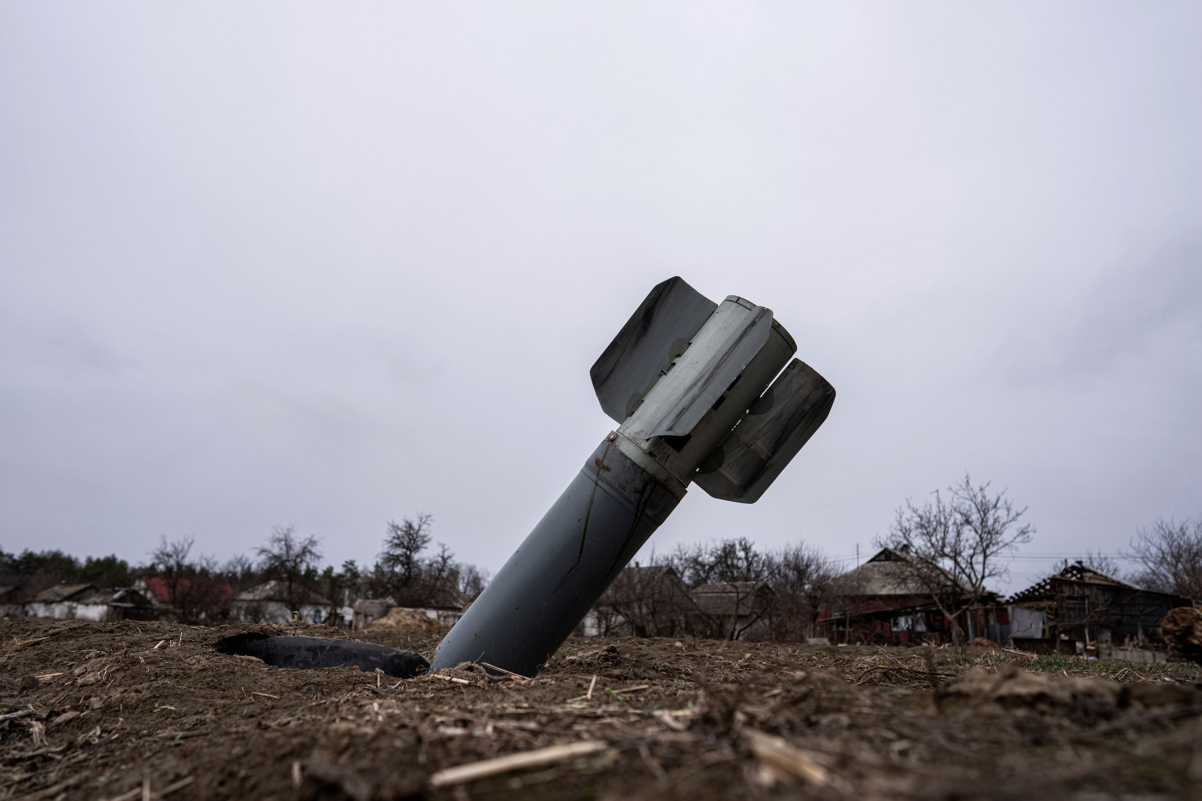 The tail of a missile sticks out in a residential area in Yahidne, near Dnipro on April 12. (Evgeniy Maloletka—AP)