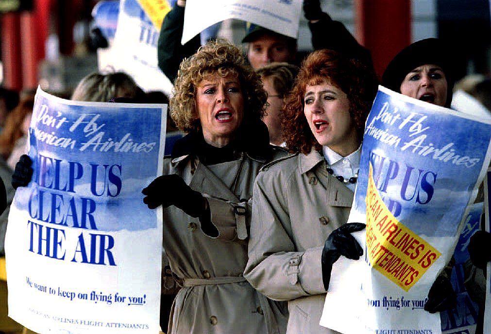 Striking American Airlines flight attendants chant slogans in November 1993 as they march on a picket line.