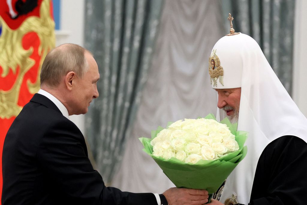 Russia's President Vladimir Putin congratulates Patriarch Kirill of Moscow and All Russia during a presentation ceremony for presenting Andrew the First-Called order in Moscow on Nov. 20, 2021. (Mikhail Metzel—Sputnik/AFP/Getty Images)